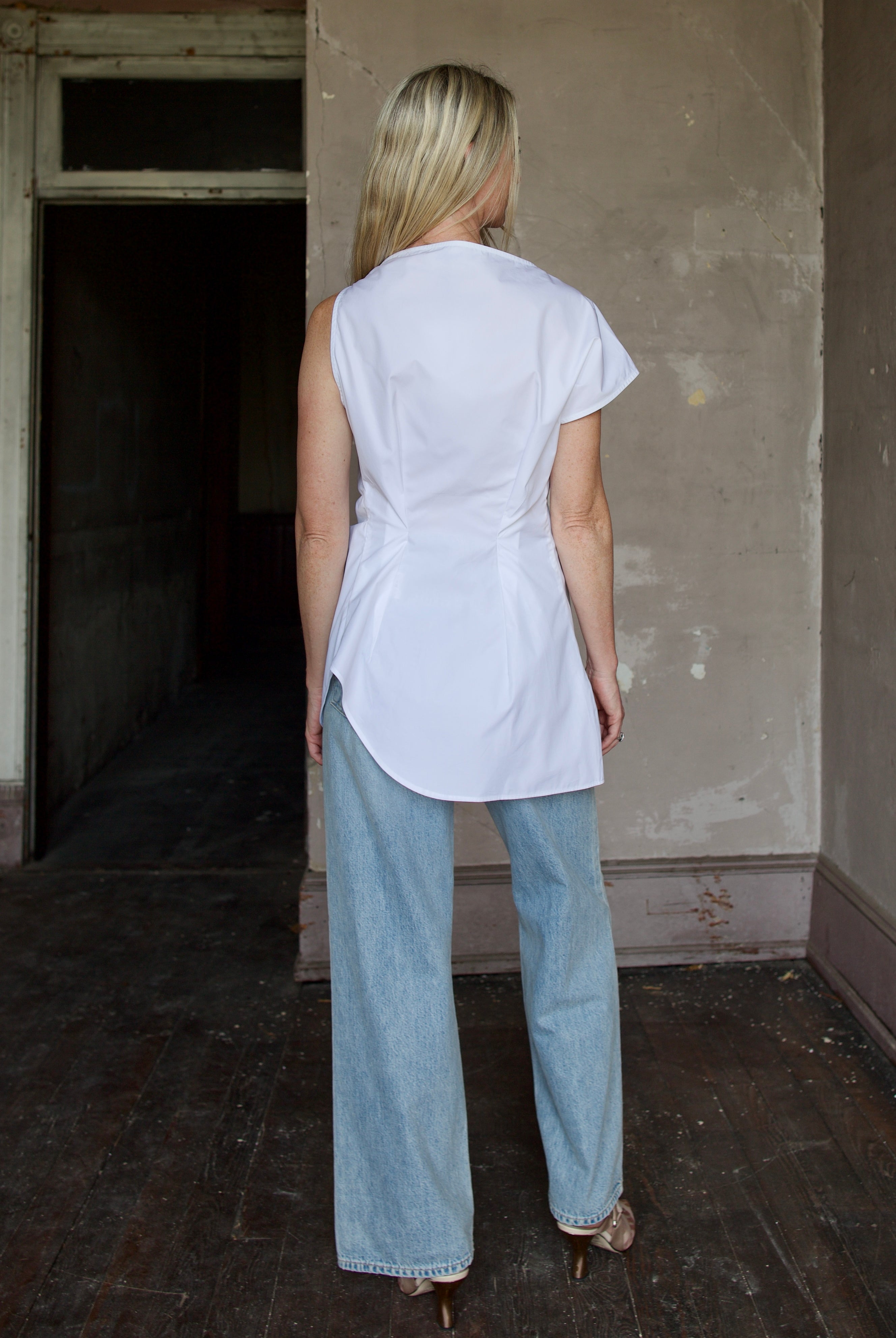 Model wearing cotton poplin shirt by Rohe with modern design and luxurious craftsmanship to elevate style with asymmetrical tailoring