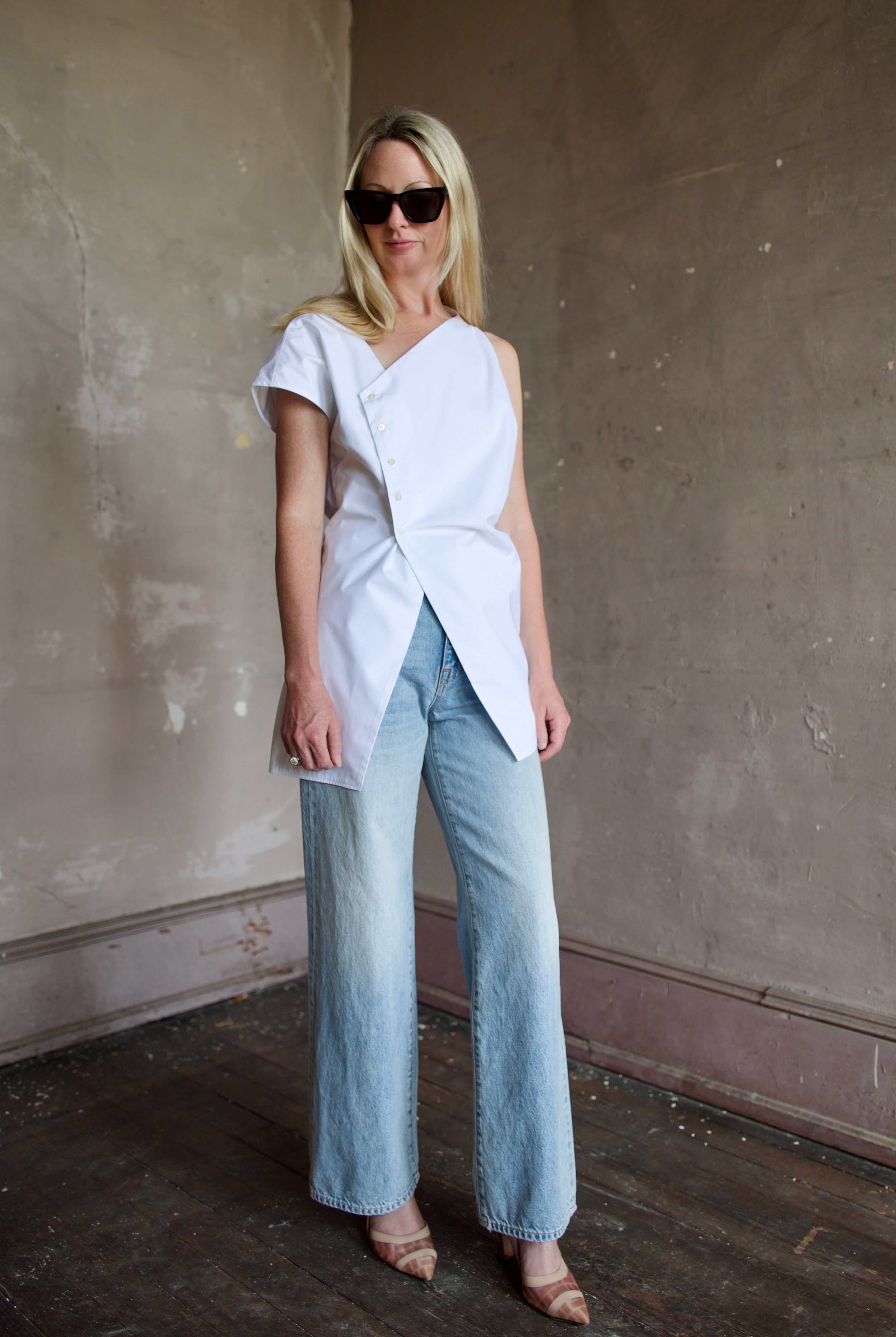 Model wearing cotton poplin shirt by Rohe with modern design and luxurious craftsmanship to elevate style with asymmetrical tailoring