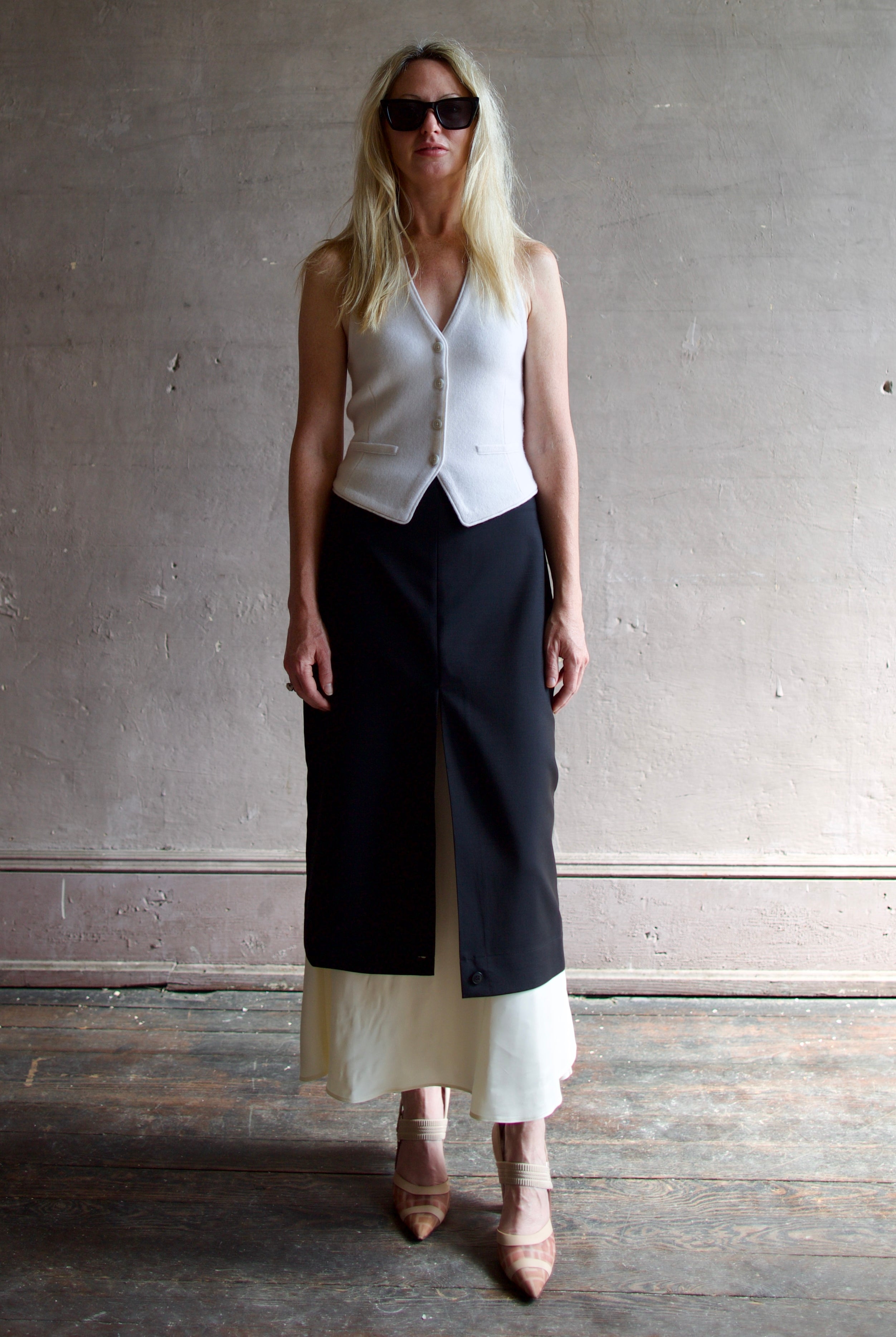 Model wearing modern Amsterdam designer Rohe contrast upside down skirt in black with luxury classic tailoring