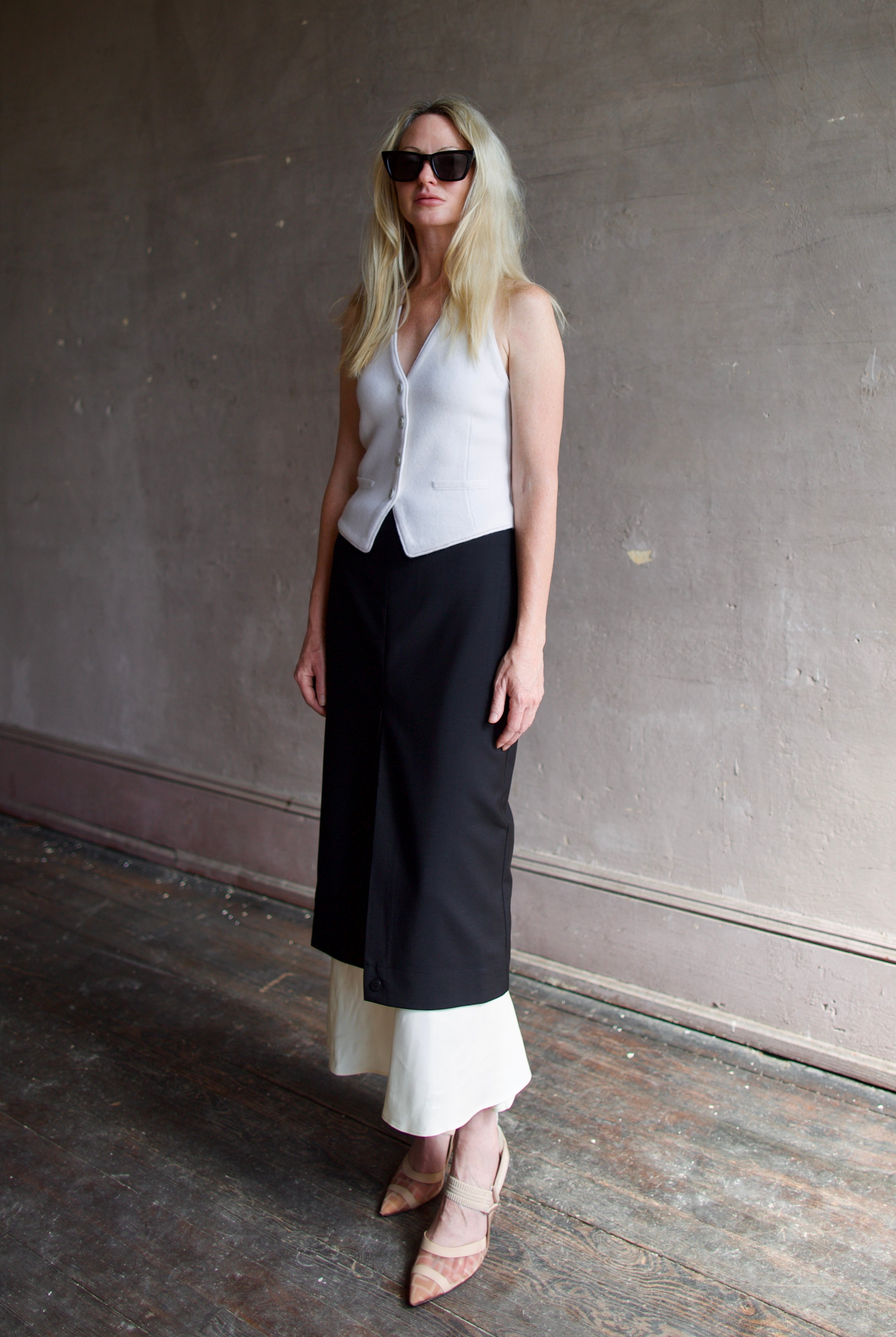 Model wearing modern Amsterdam designer Rohe contrast upside down skirt in black with luxury classic tailoring