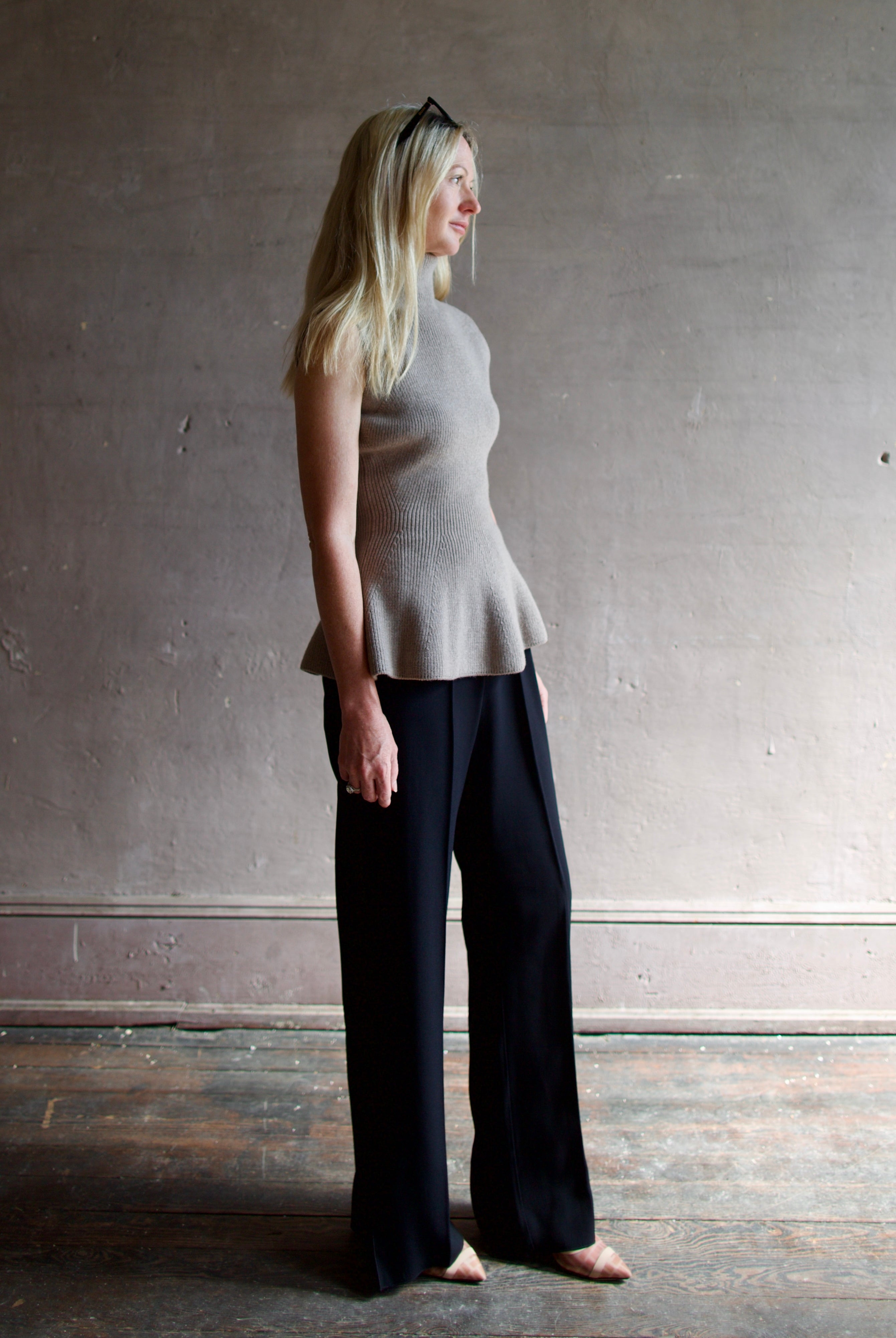 Model wearing luxury Rohe sculptural sleeveless knitted top with refined sophisticated modern silhouette for premium quality neutral taupe top