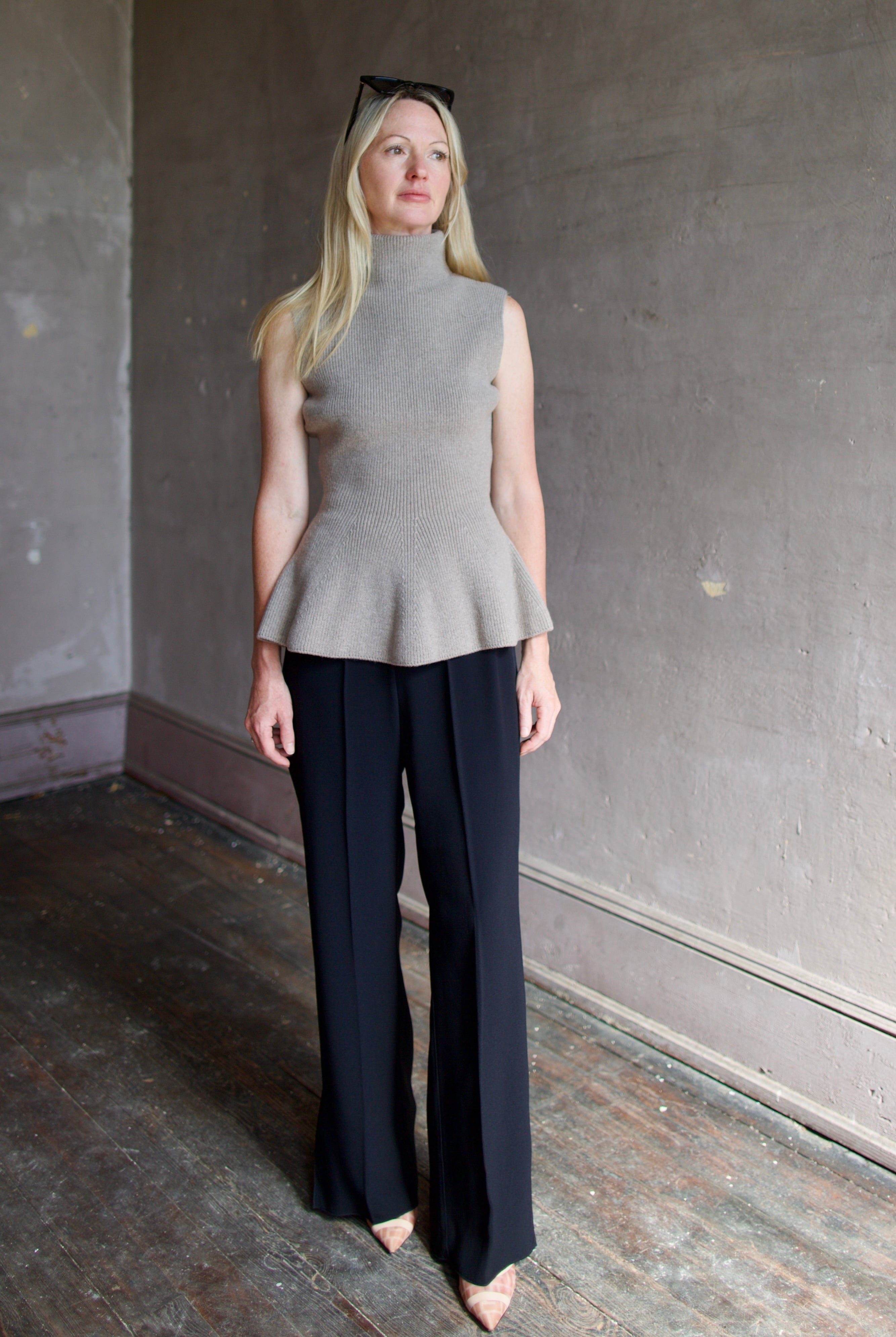 Model wearing luxury brand Rohe sculptural sleeveless knitted top with refined sophisticated modern silhouette for premium quality minimalist