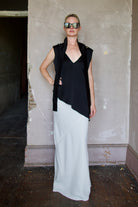 Model wearing reversible black sleeveless satin top with expertly crafted draping by luxury modern designer Rohe