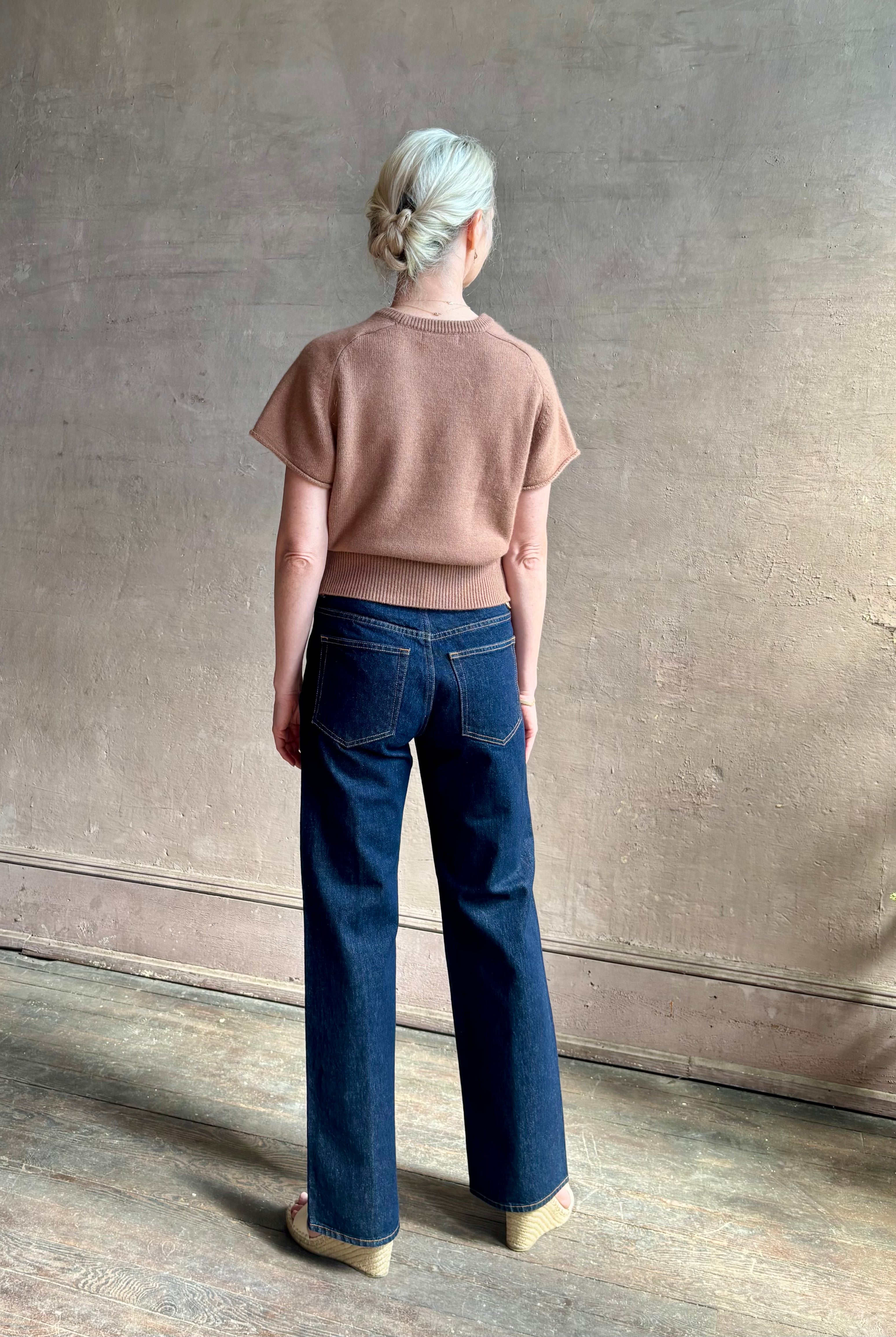 Woman wearing elegant luxury brand SABLYN Jones Saddle Raglan Cashmere Sweater neutral copper tone