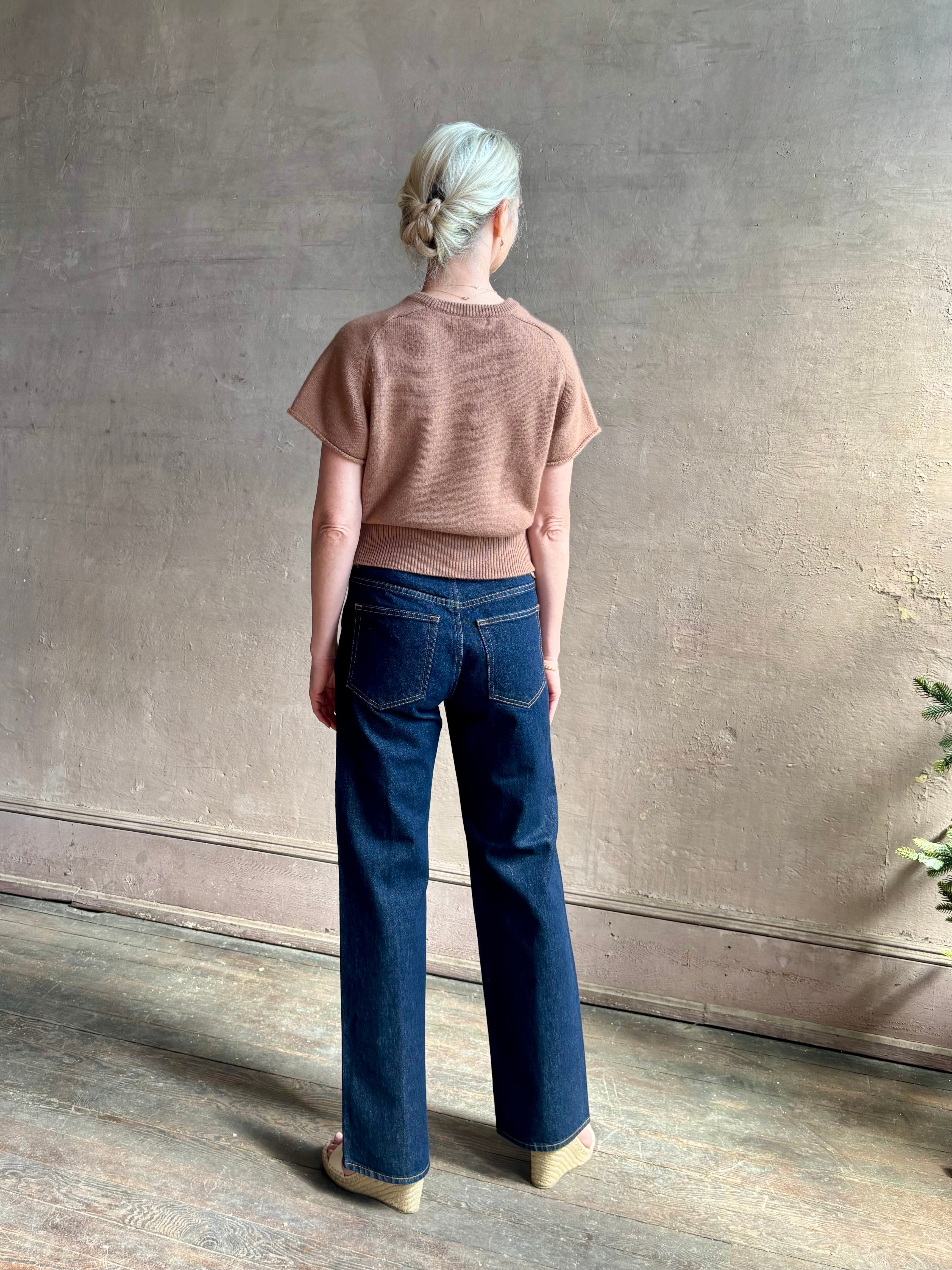 Woman wearing elegant luxury brand SABLYN Jones Saddle Raglan Cashmere Sweater neutral copper tone