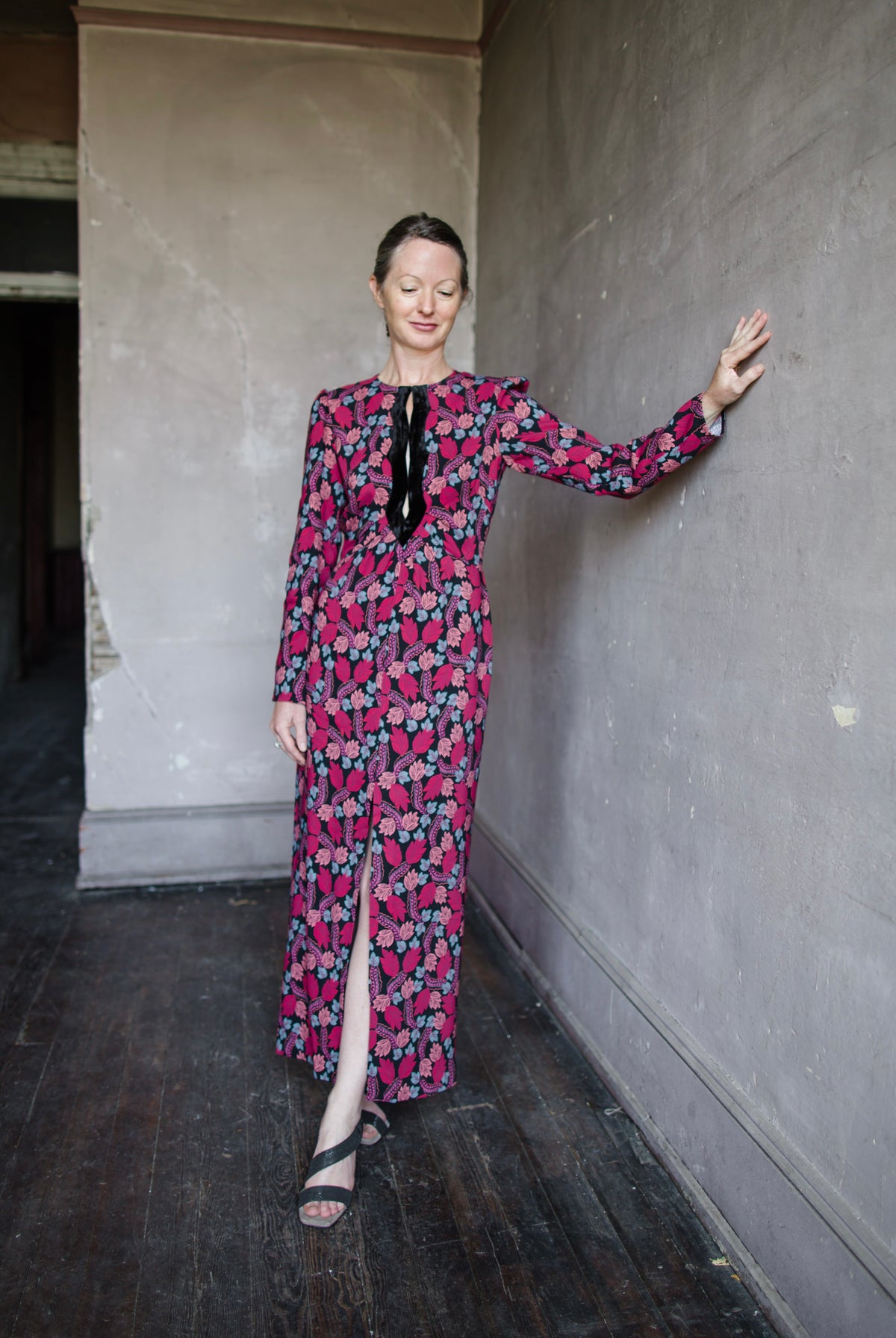 Image featuring a woman wearing the Jinx-C silk dress by Saloni with a crew neckline, long sleeves, and velvet trim cutouts down the front autumnal print