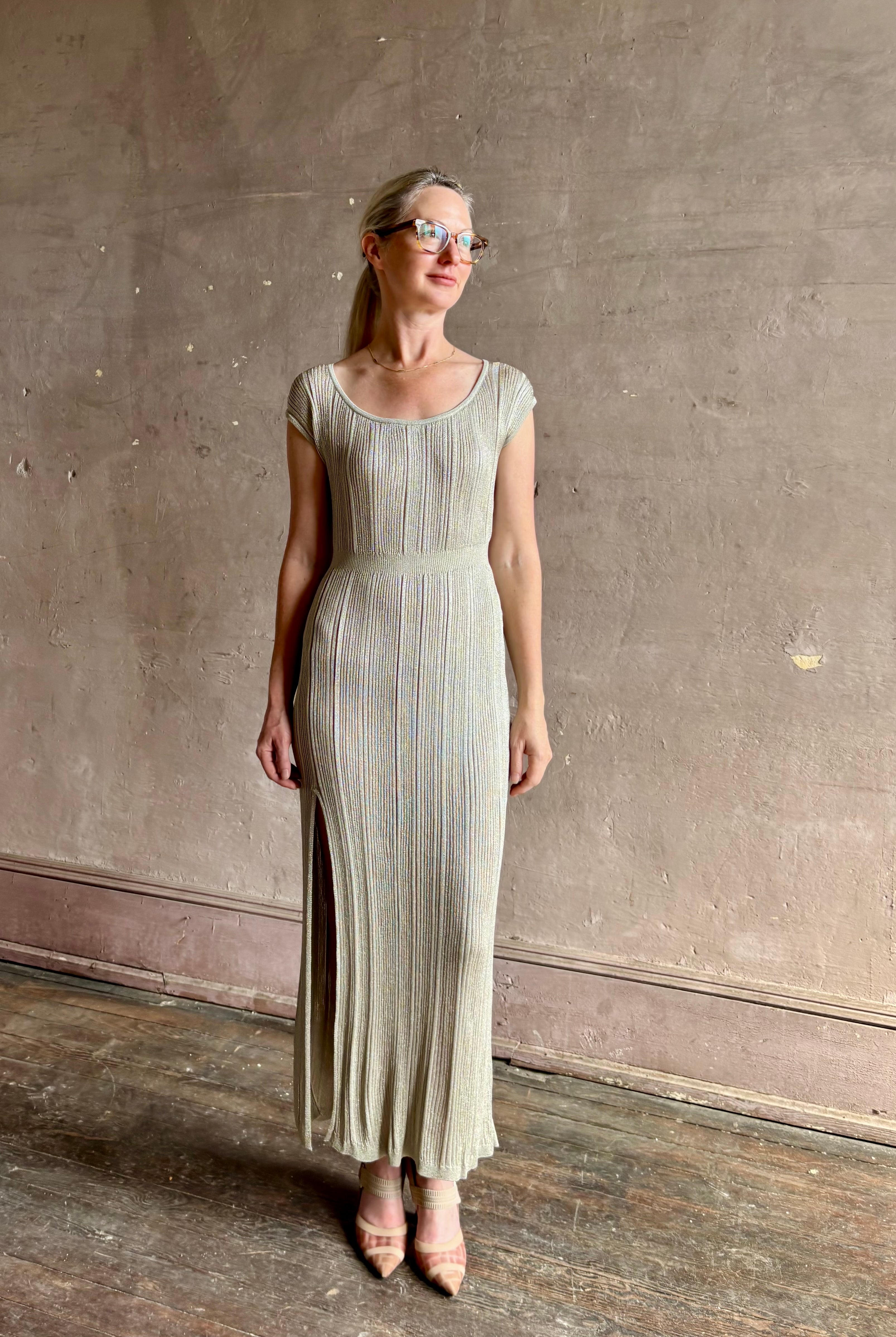 woman wearing saloni stardust cap sleeve floor-length ribbed knit dress front leg vent round neck fitted silver metallic