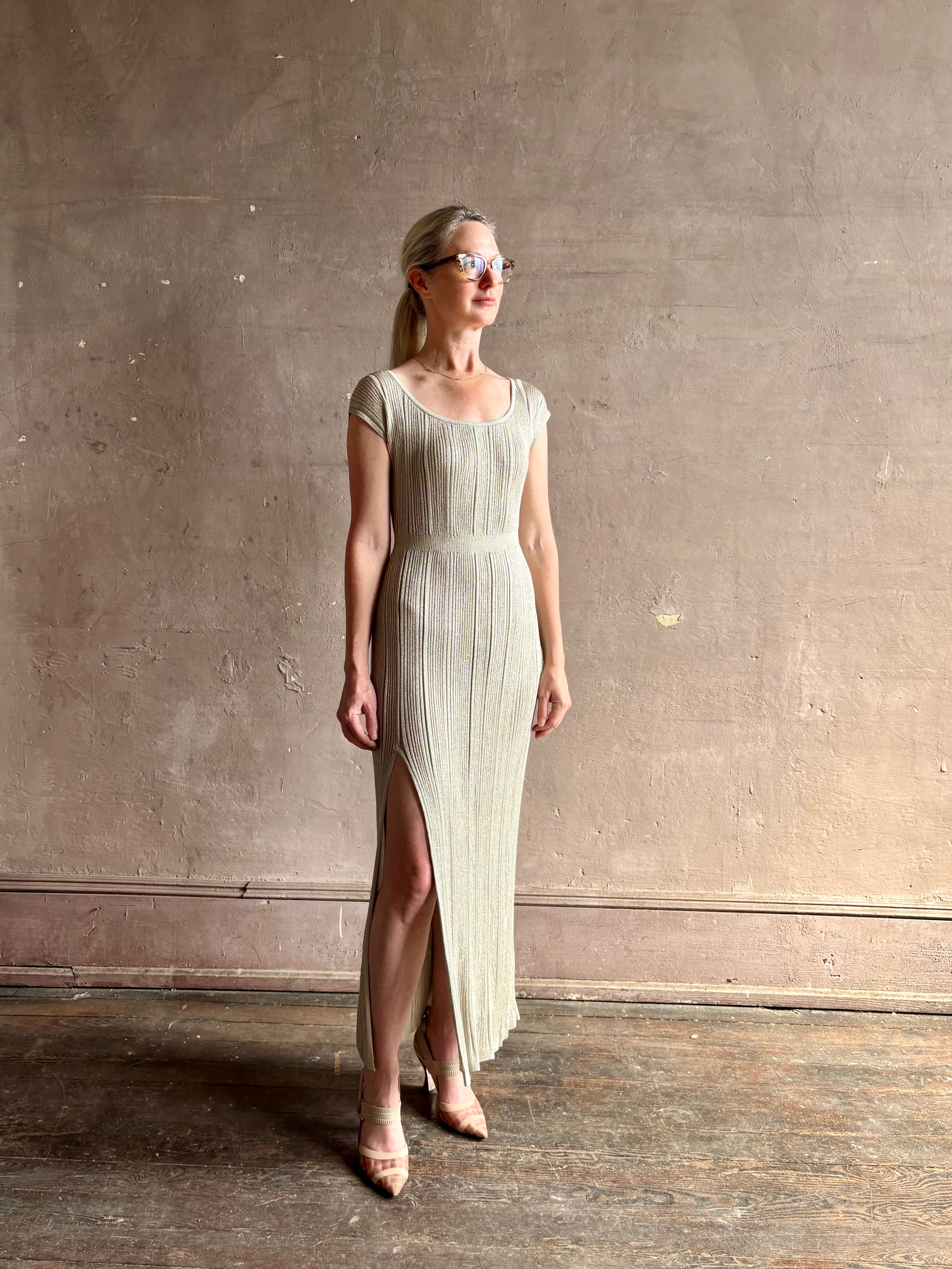 woman wearing saloni stardust cap sleeve floor-length ribbed knit dress front leg vent round neck fitted silver