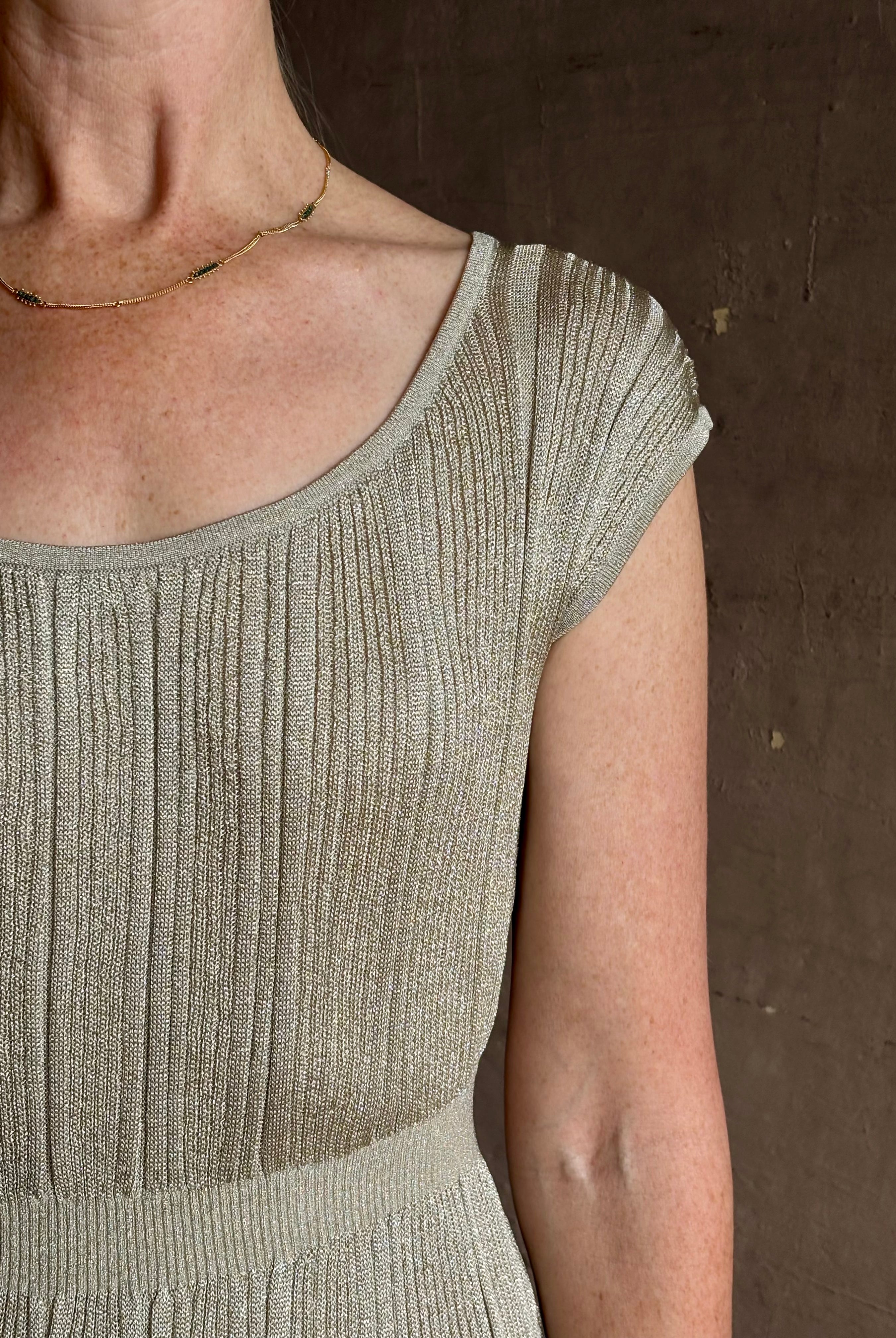 woman wearing saloni stardust cap sleeve floor-length ribbed knit dress front leg vent round neck fitted silver
