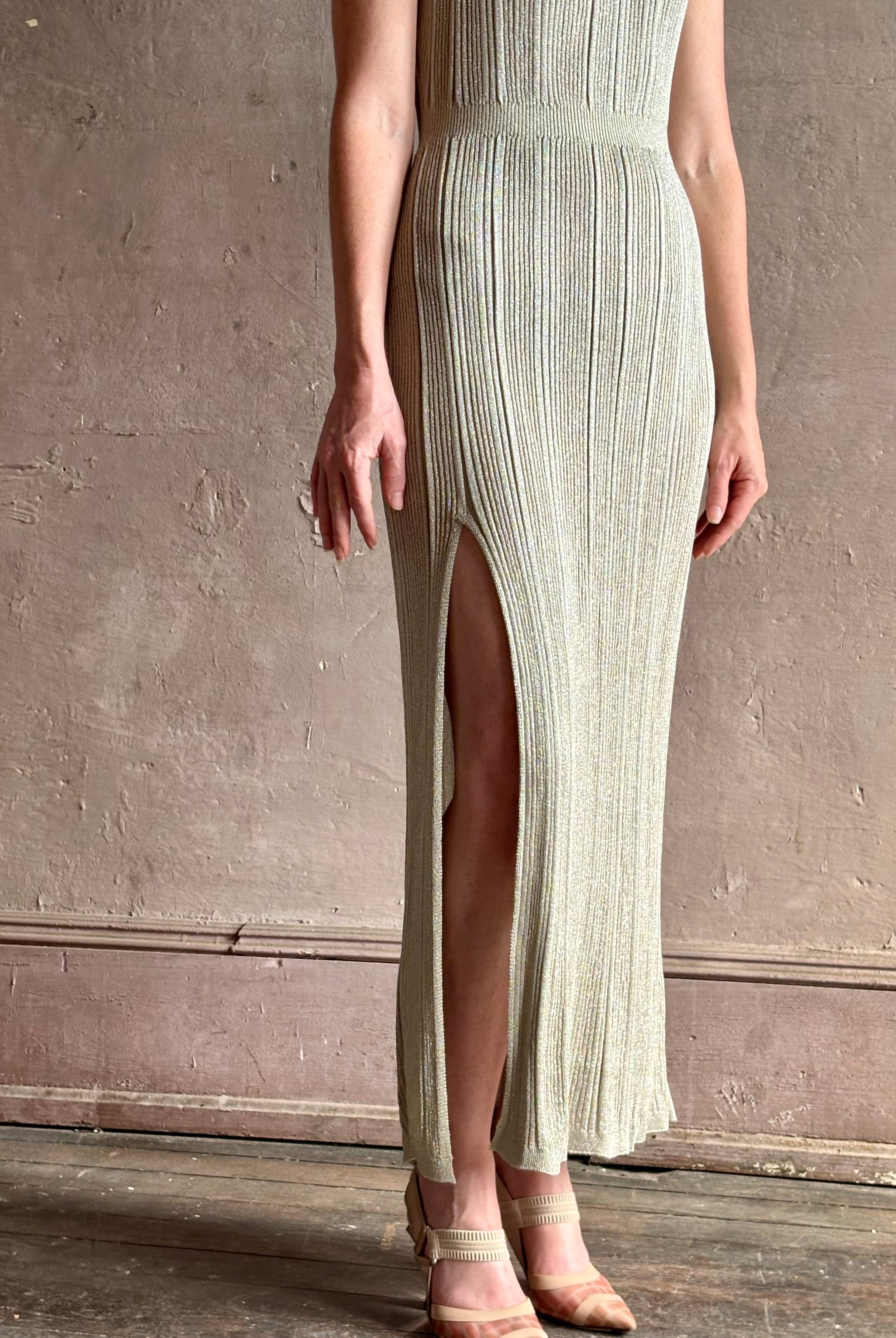 woman wearing saloni stardust cap sleeve floor-length ribbed knit dress front leg vent round neck fitted silver
