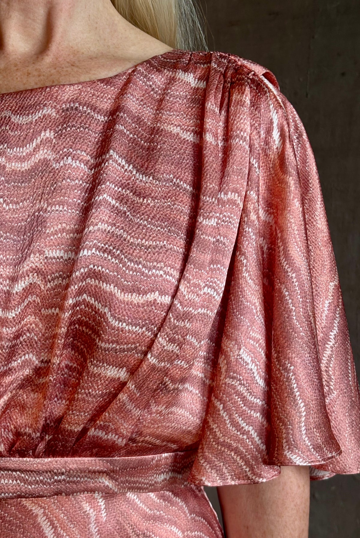 Mature woman wearing Saloni silk Winona Dress in Blush Marbling print V-back detail short sleeves empire waist Romantic occasion gown
