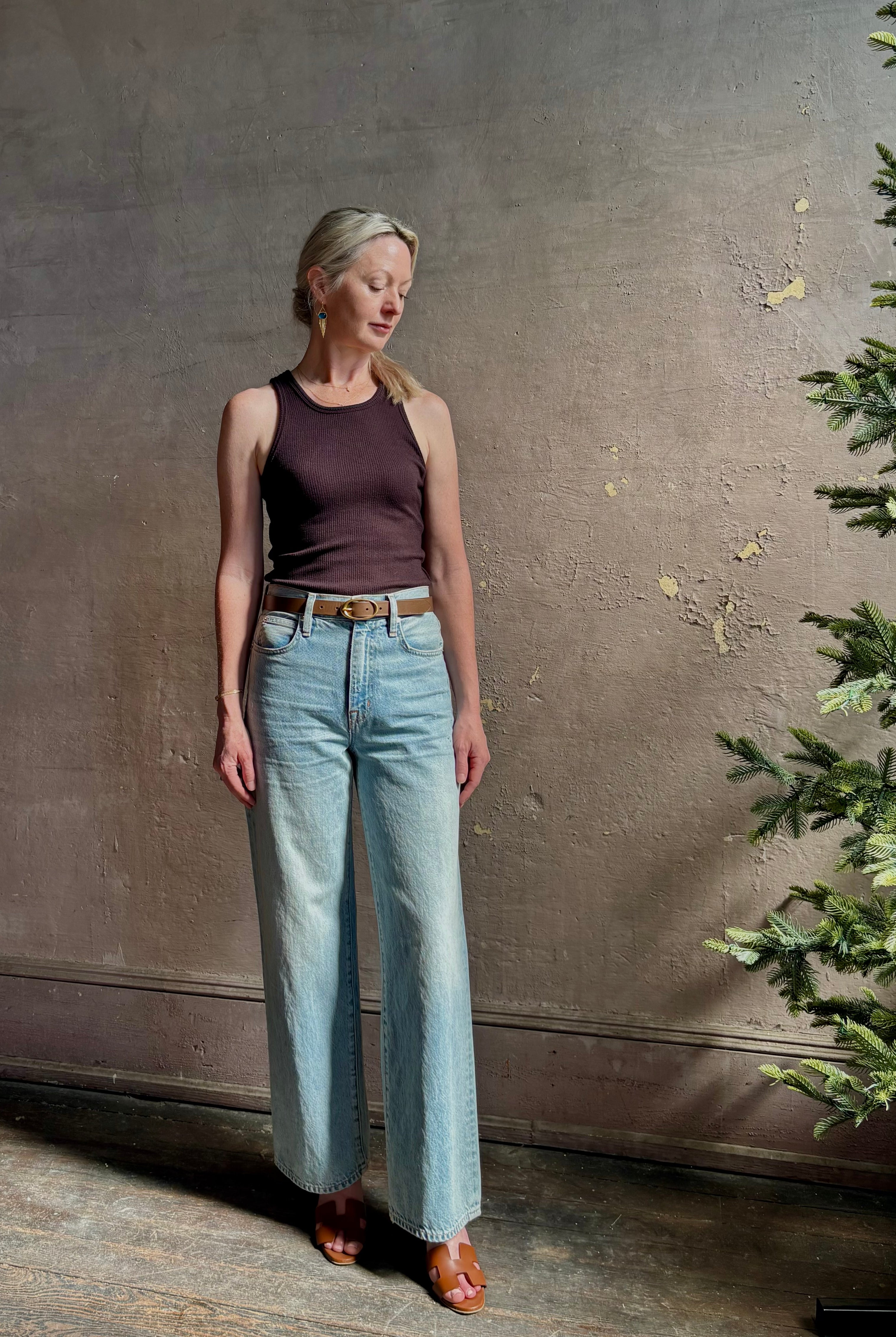 Mature woman wearing Slvrlake Grace Ankle ridgid cotton jeans with a high rise zipper wide leg ankle length light wash