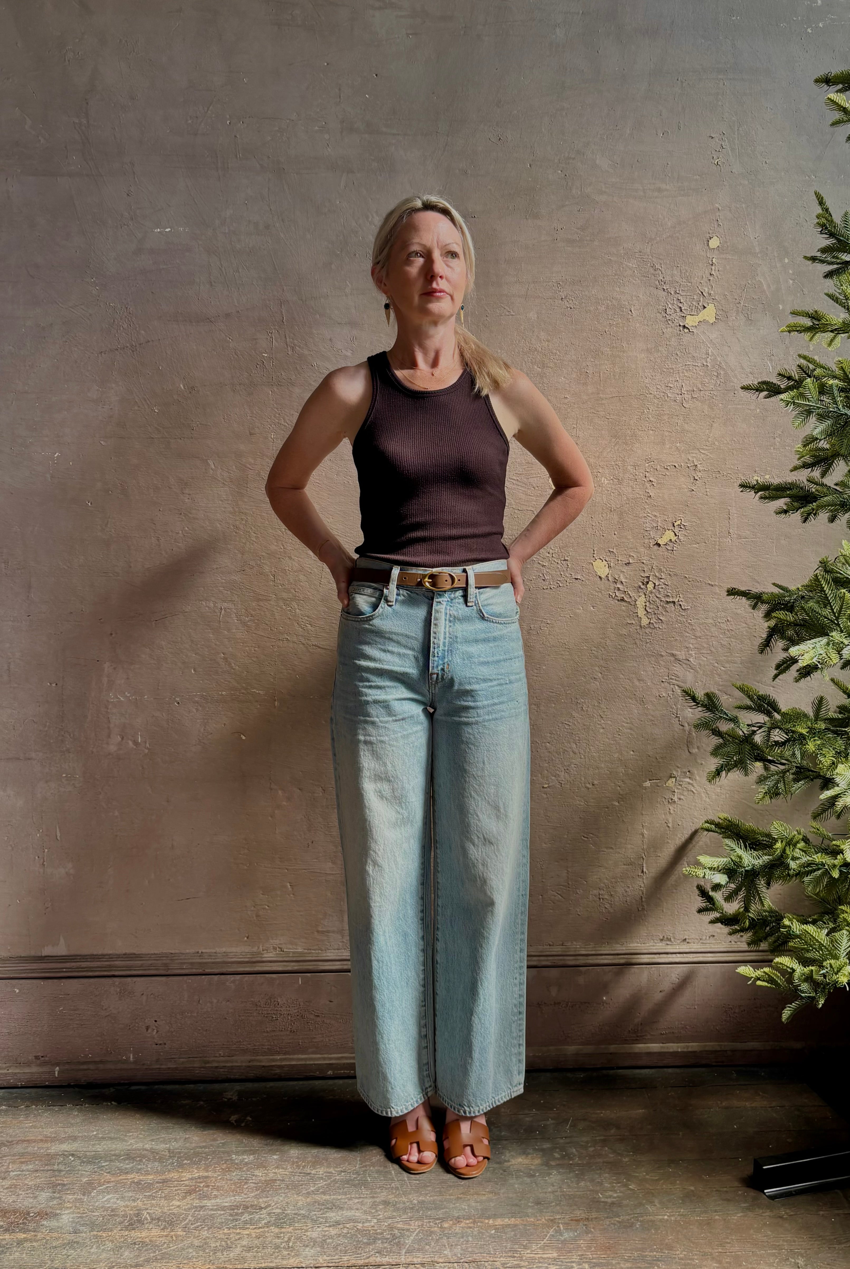 Mature woman wearing Slvrlake Grace Ankle ridgid cotton jeans with a high rise zipper wide leg ankle length light wash