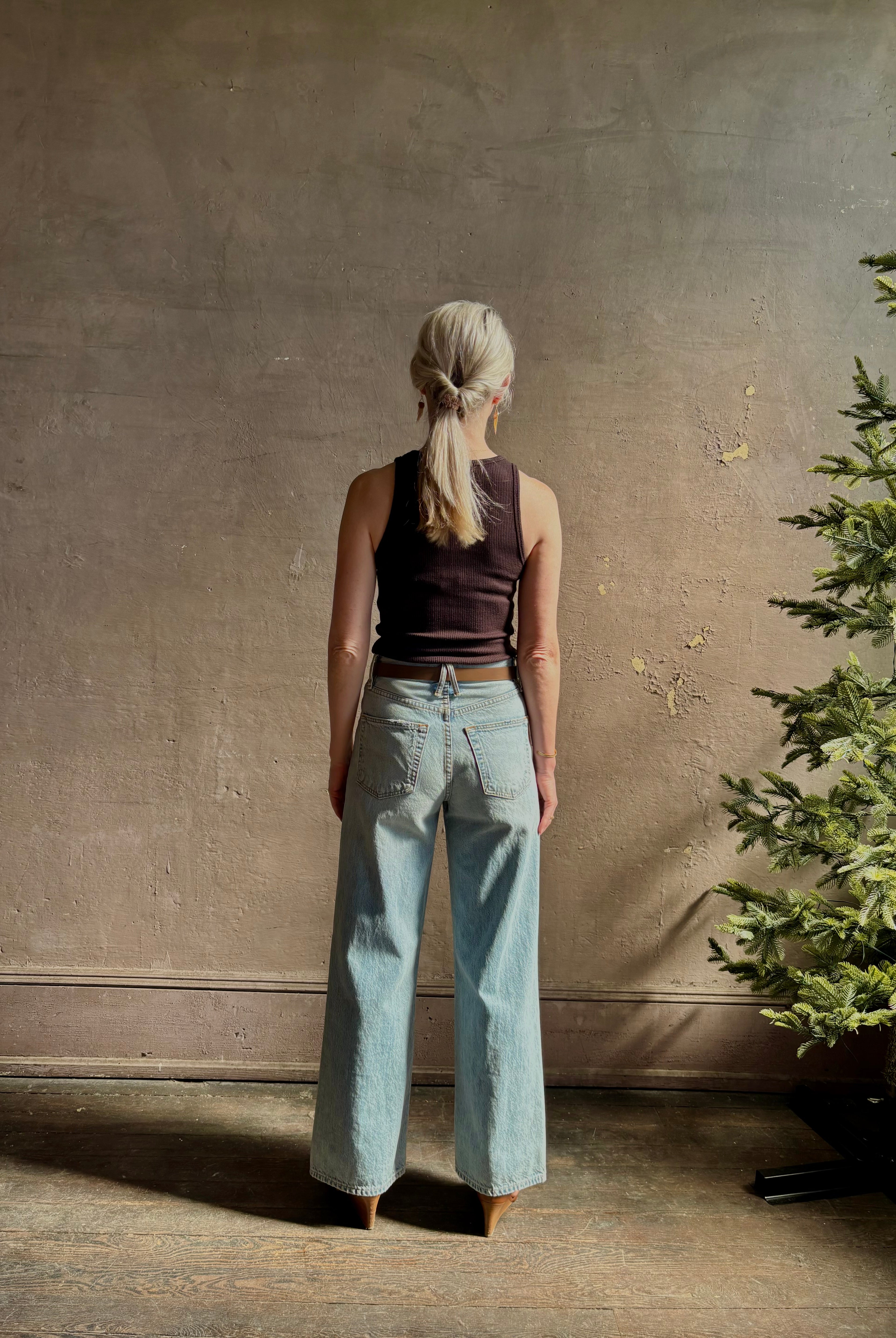 Mature woman wearing Slvrlake Grace Ankle ridgid cotton jeans with a high rise zipper wide leg ankle length light wash