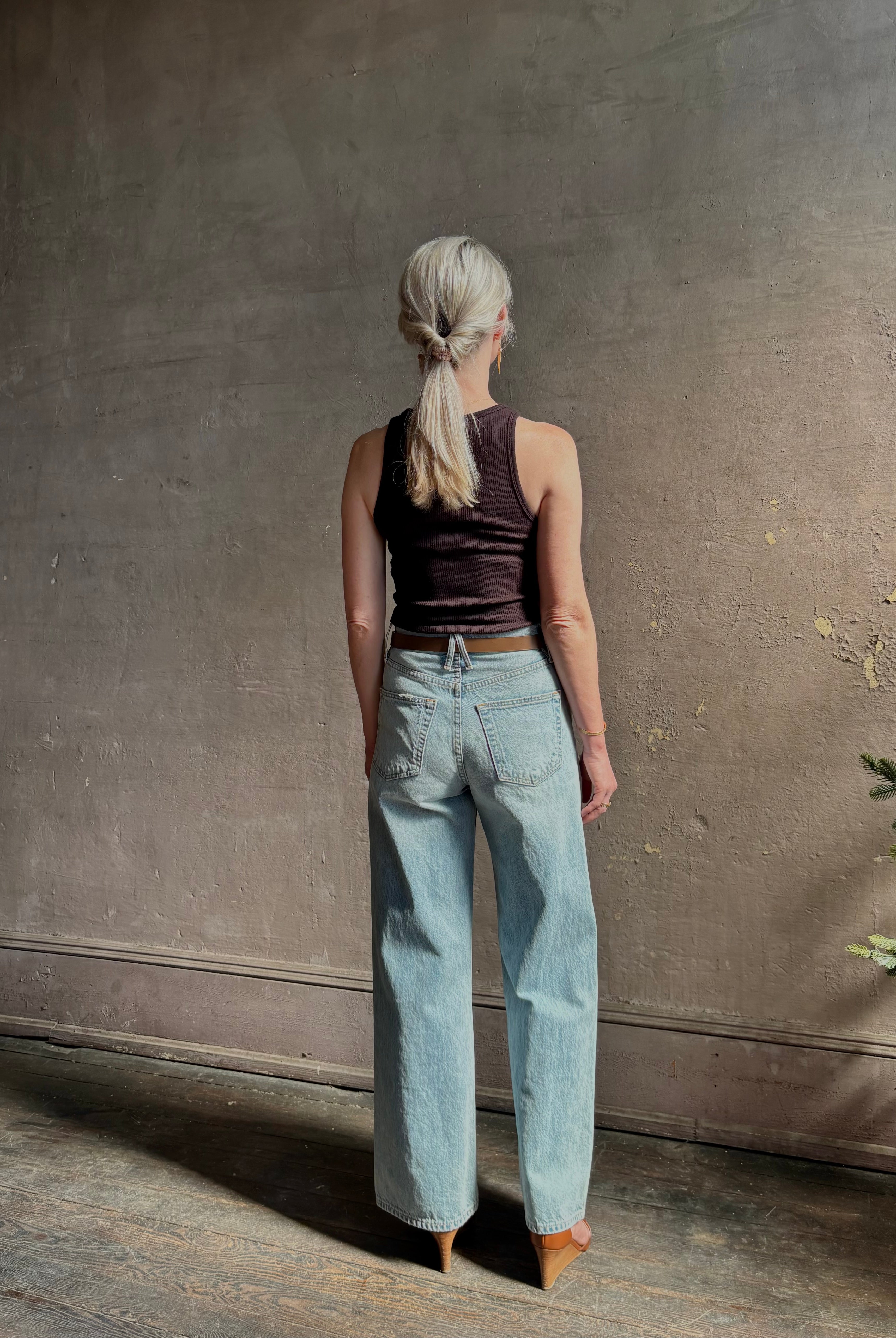 Mature woman wearing Slvrlake Grace Ankle ridgid cotton jeans with a high rise zipper wide leg ankle length light wash