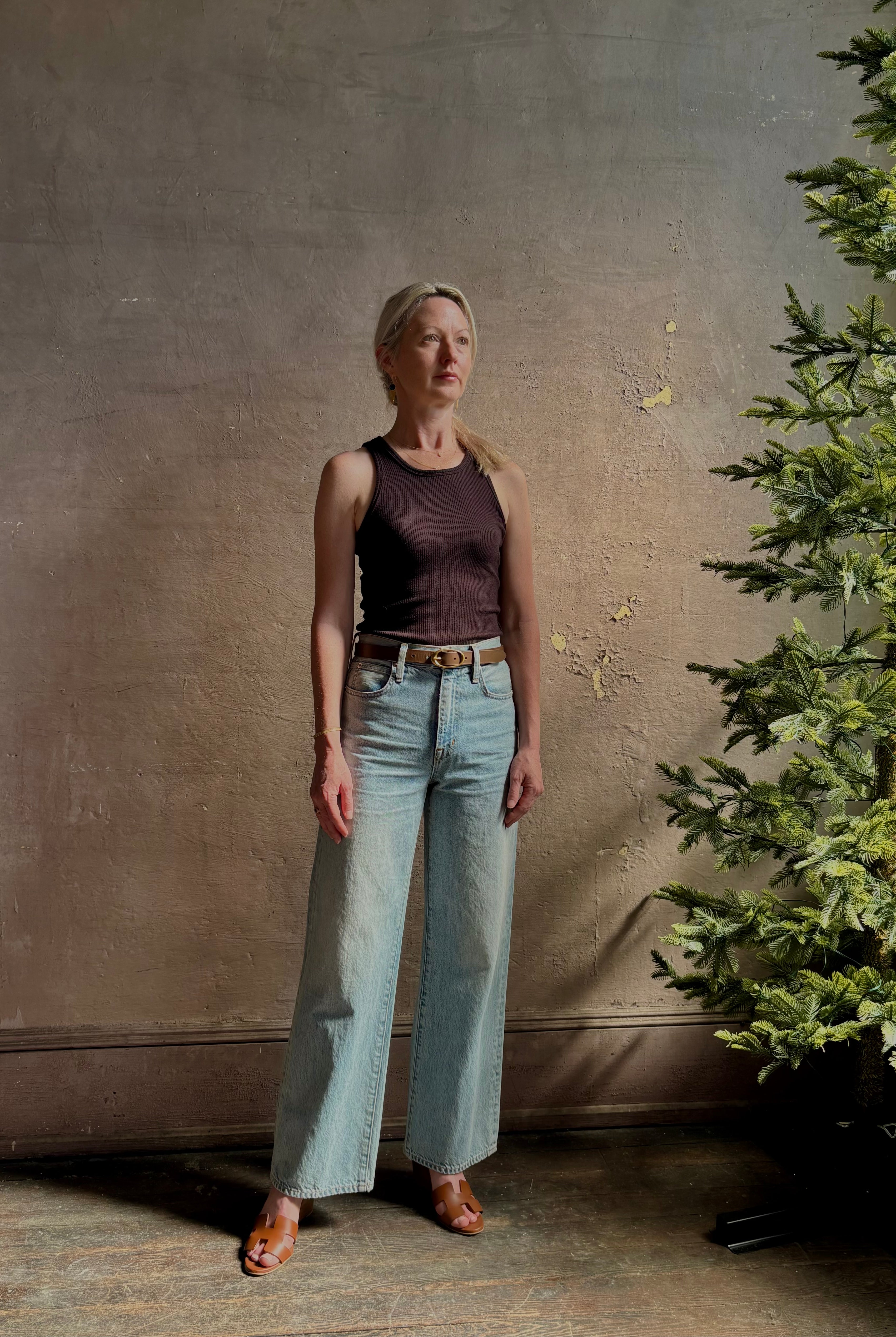 Mature woman wearing Slvrlake Grace Ankle ridgid cotton jeans with a high rise zipper wide leg ankle length light wash