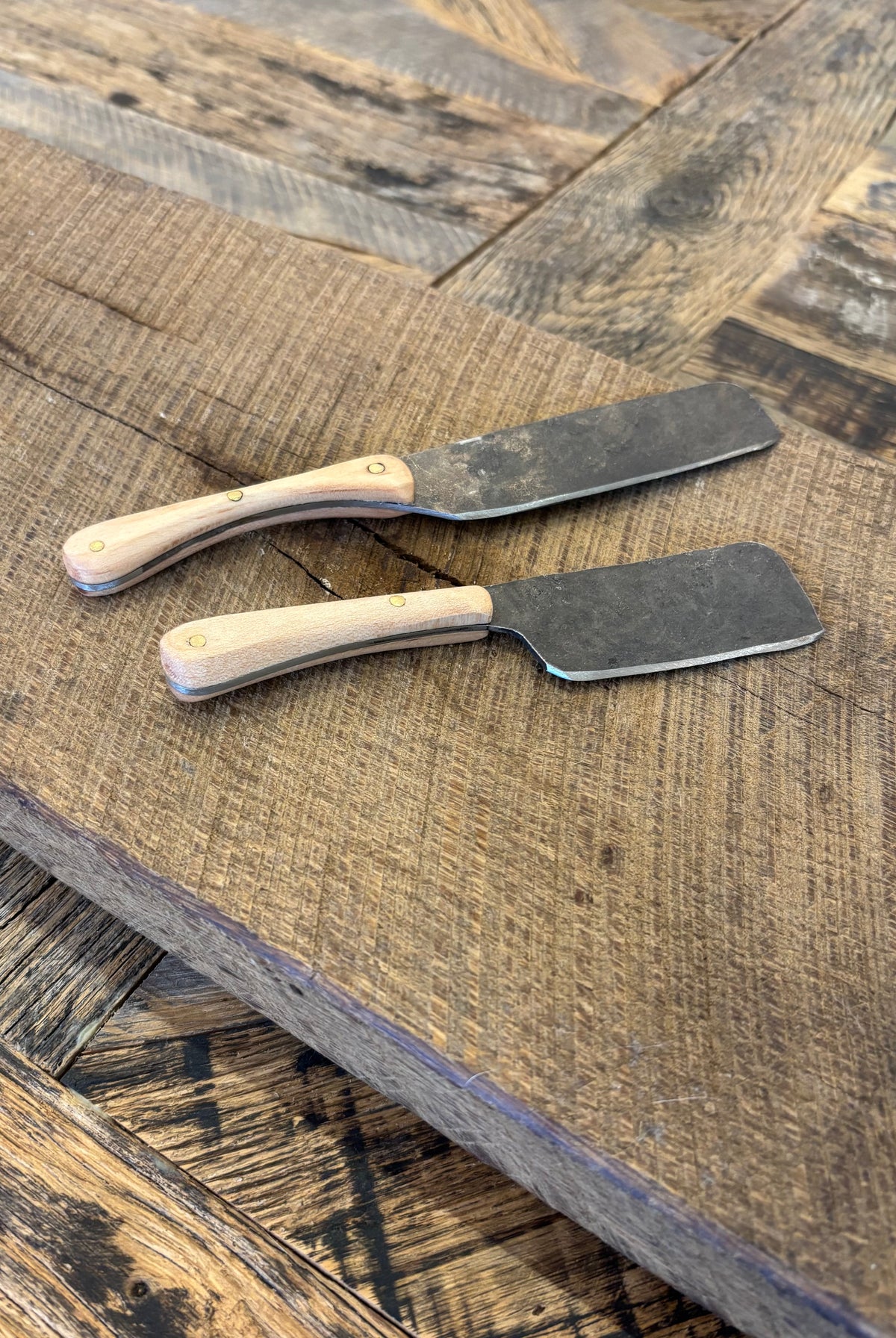 A small and large rustic modern charcuterie serving knife set with hand-forged steel blade and maple wooden handle hand crafted in USA
