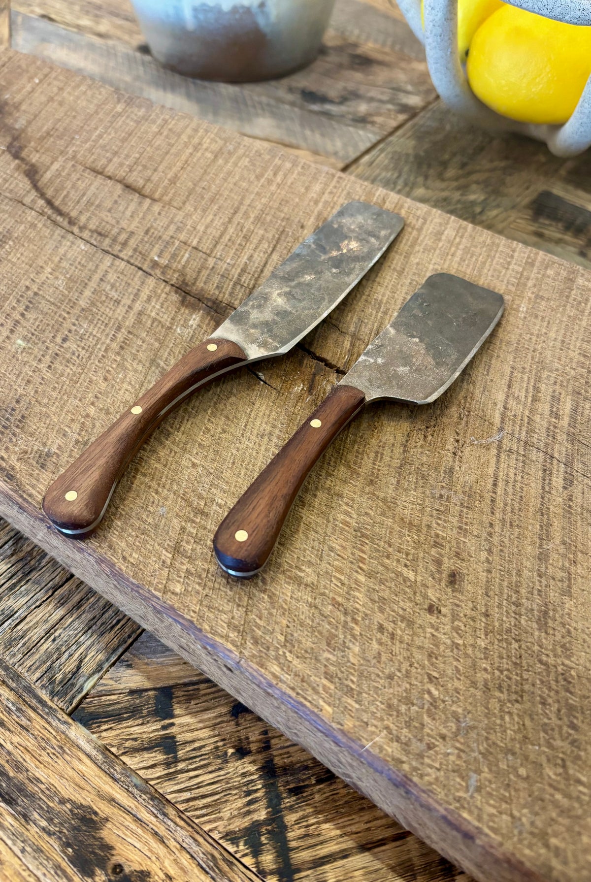 A small and large rustic modern charcuterie serving knife set with hand-forged steel blade and a walnut wooden handle hand crafted in USA