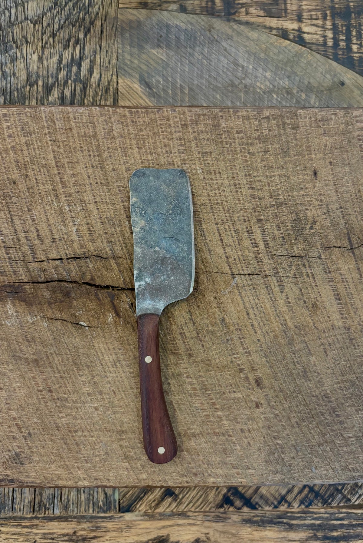 A small rustic modern charcuterie serving knife with hand-forged steel blade and a walnut wooden handle hand crafted in USA