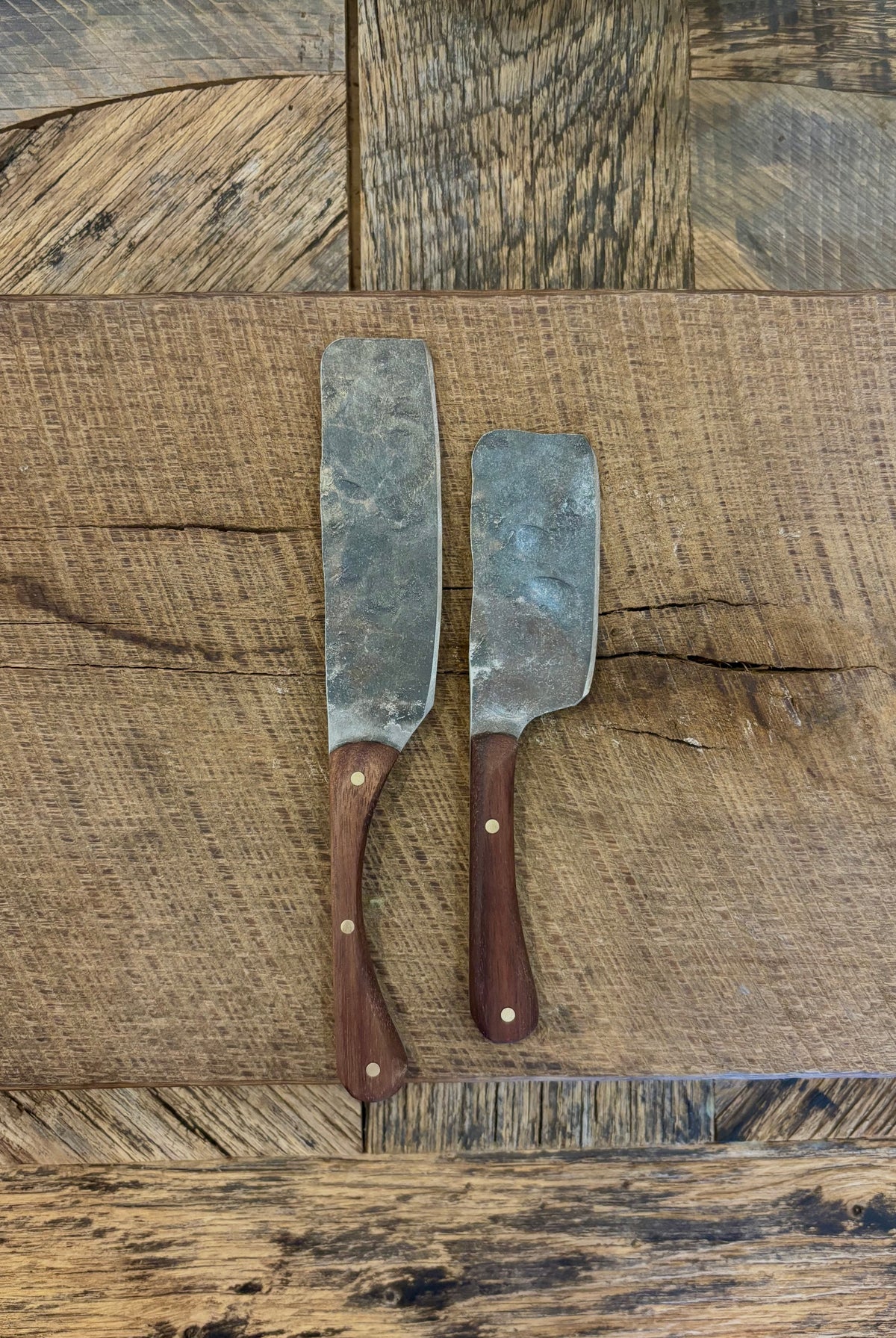 A small and large rustic modern charcuterie serving knife set with hand-forged steel blade and a walnut wooden handle hand crafted in USA