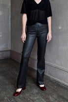 Model wearing SPRWMN Black Ankle Flare Leather Pants - Designer Mid-Rise Stretch Leather