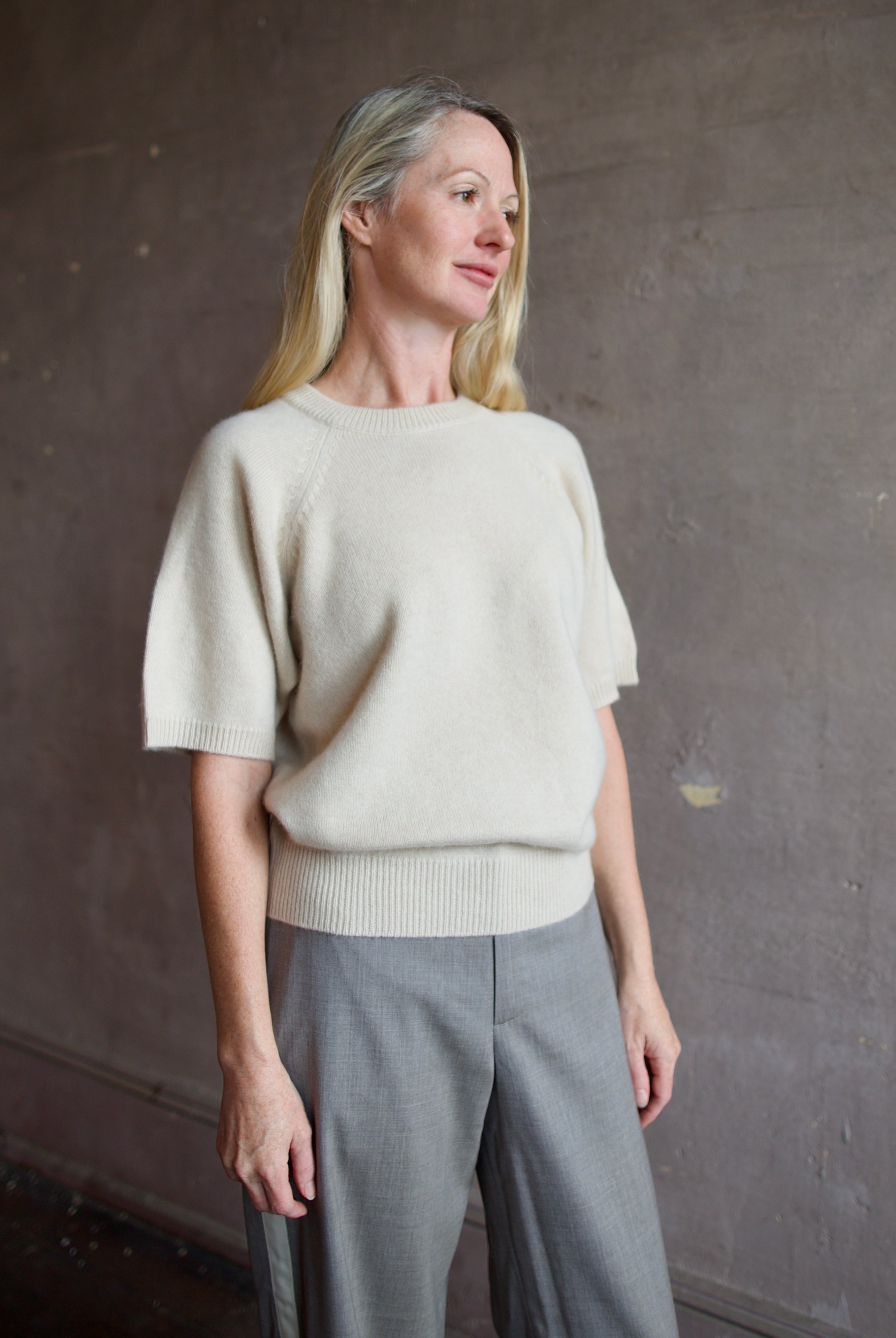 Model wearing luxury brand SPRWMN quality cashmere sweater with fitted ribbed waistband and comfortable relaxed fit