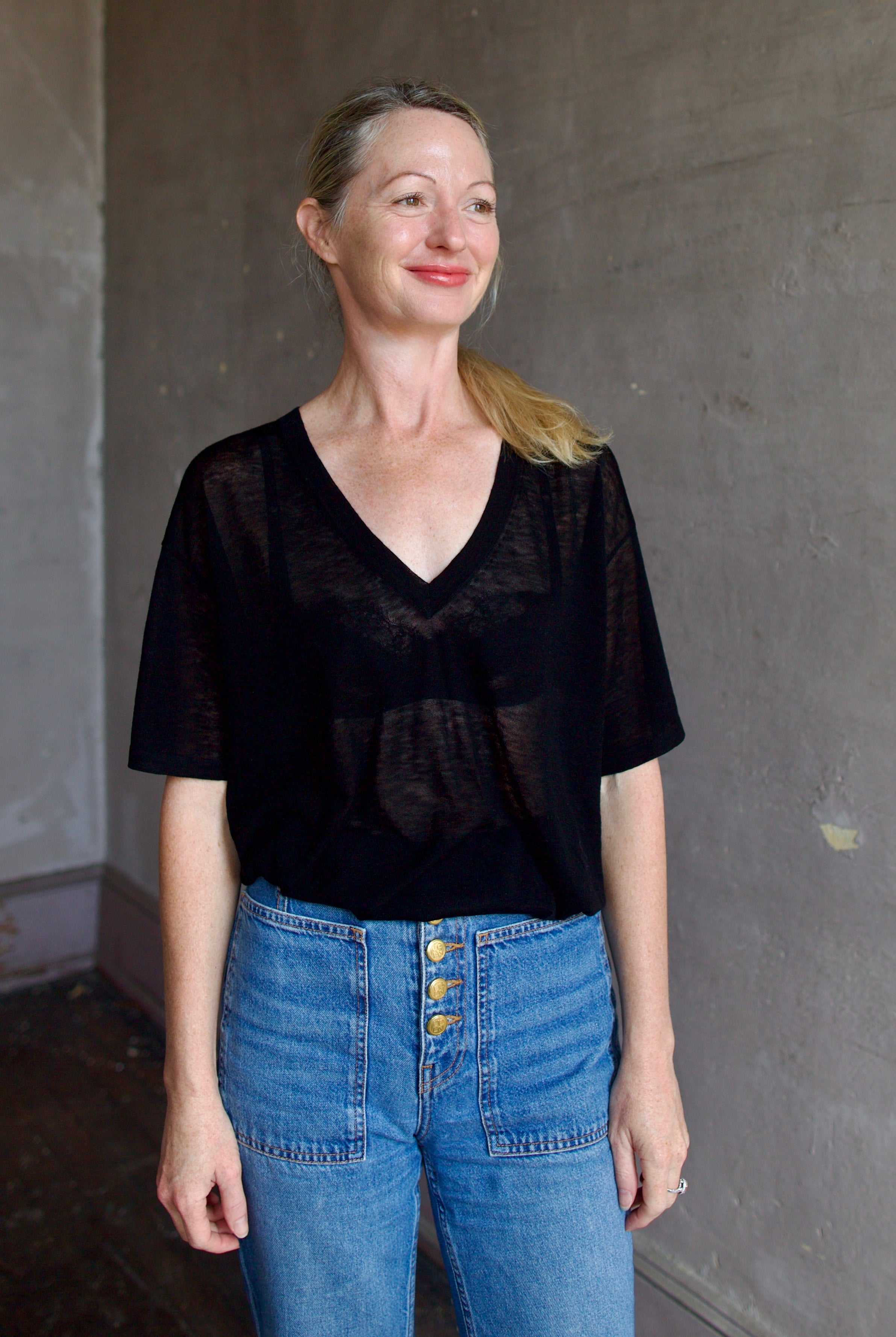 Model wearing SPRWMN Black V Neck Wool Tee - Designer Sheer Wool Short Sleeve Top