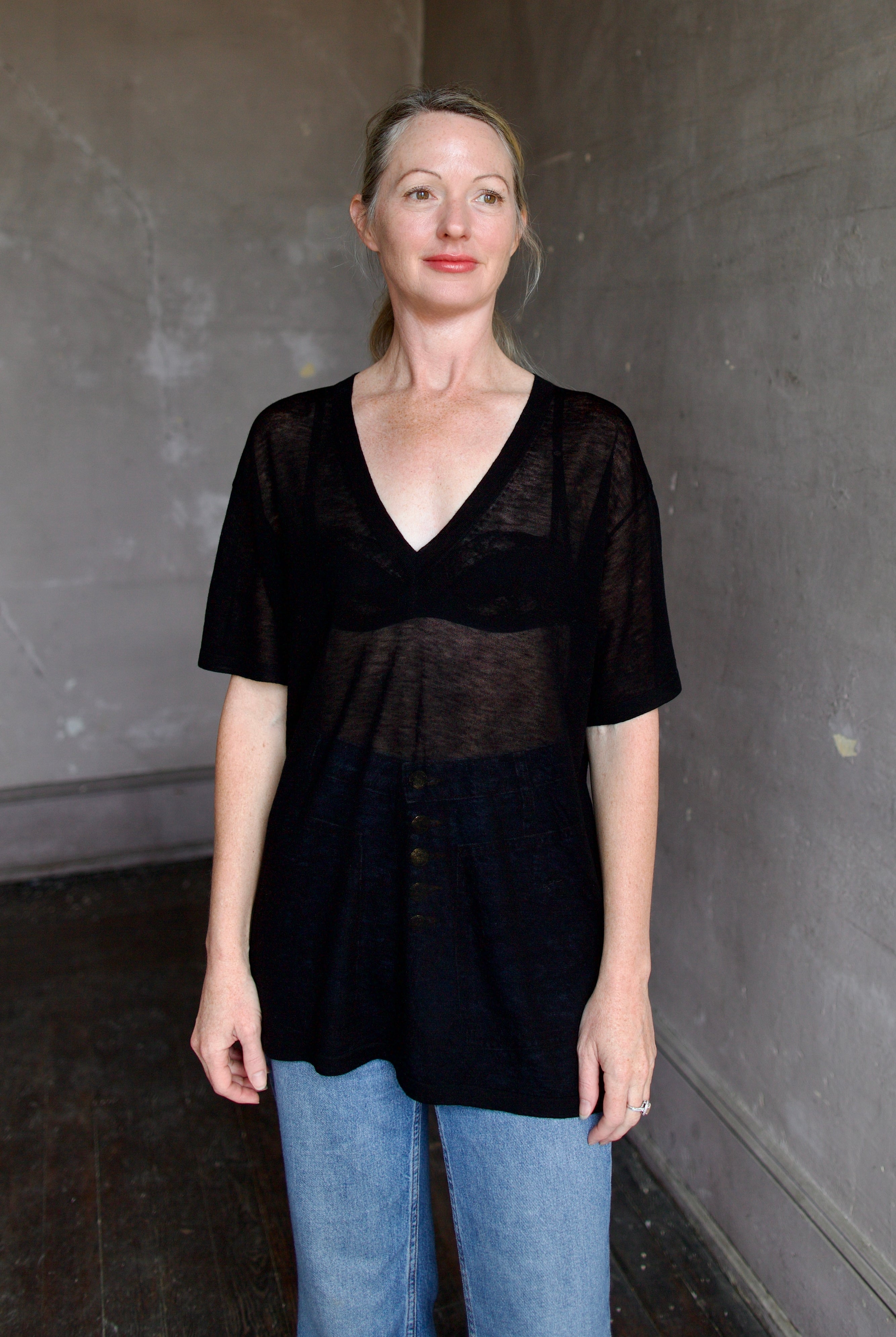 Model wearing SPRWMN Black V Neck Wool Tee - Designer Sheer Wool Short Sleeve Top