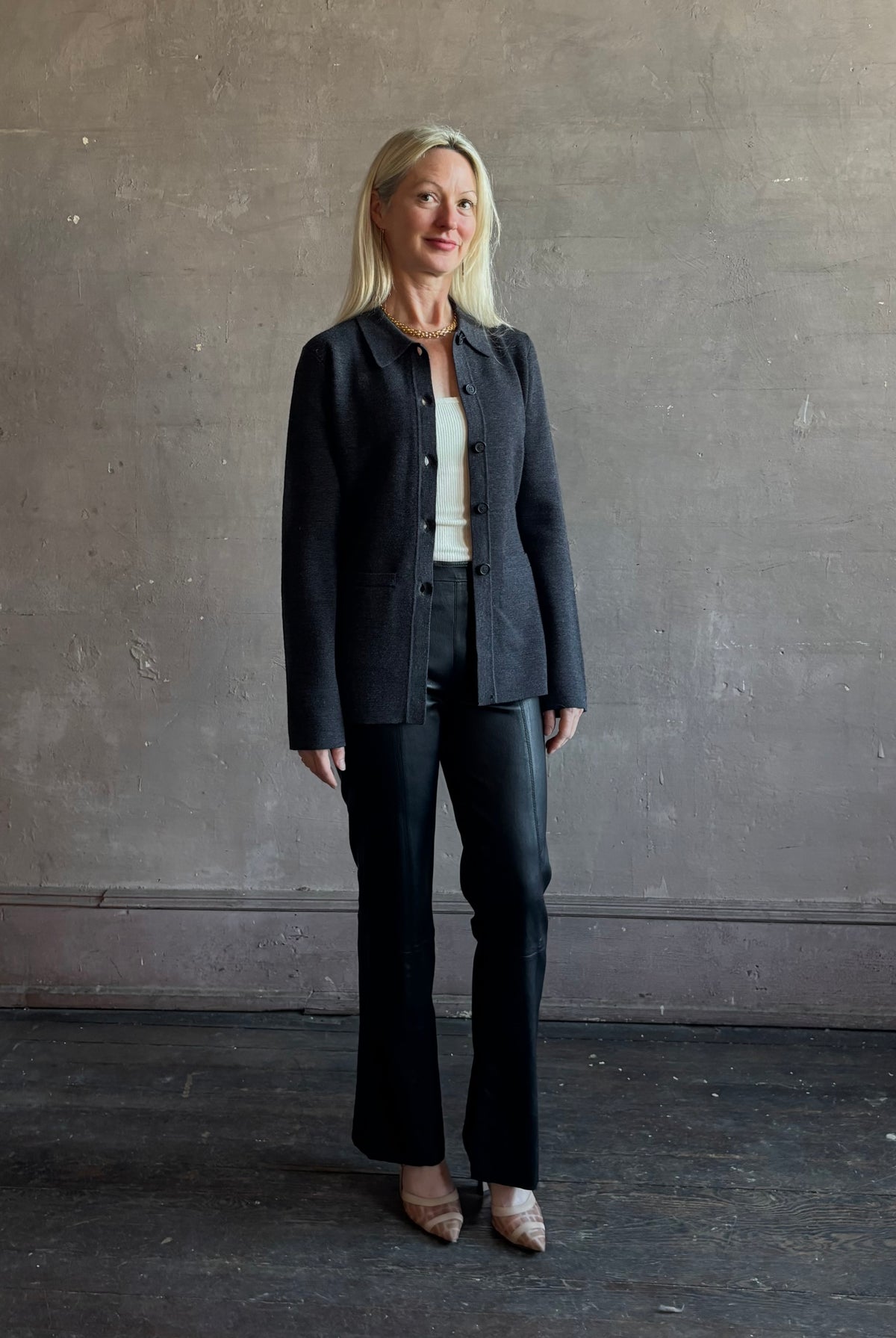 Mature woman wearing SPRWMN Black Ankle Flare Leather Pants Designer Mid-Rise Stretch Leather