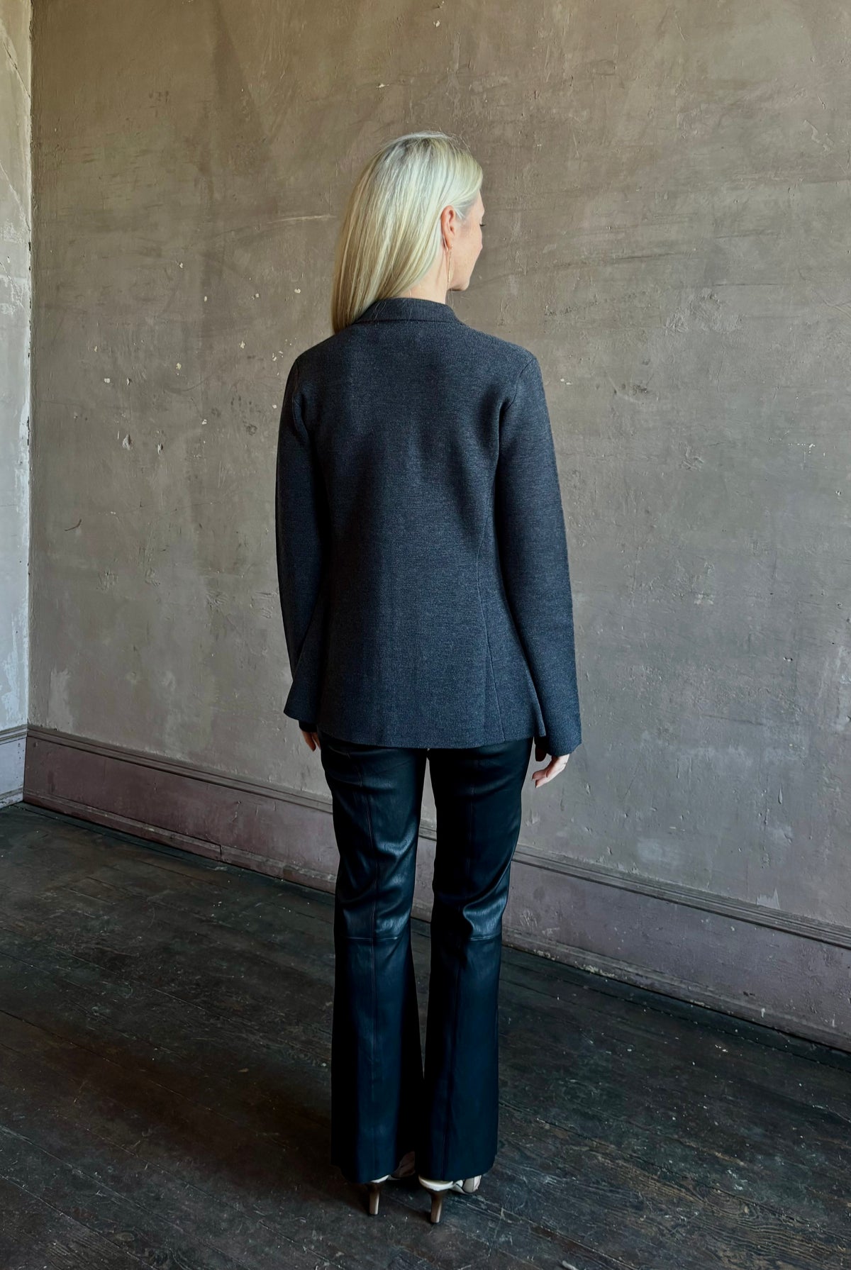 Mature woman wearing SPRWMN Black Ankle Flare Leather Pants Designer Mid-Rise Stretch Leather