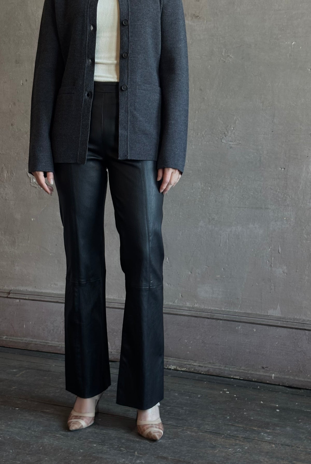 Mature woman wearing SPRWMN Black Ankle Flare Leather Pants Designer Mid-Rise Stretch Leather