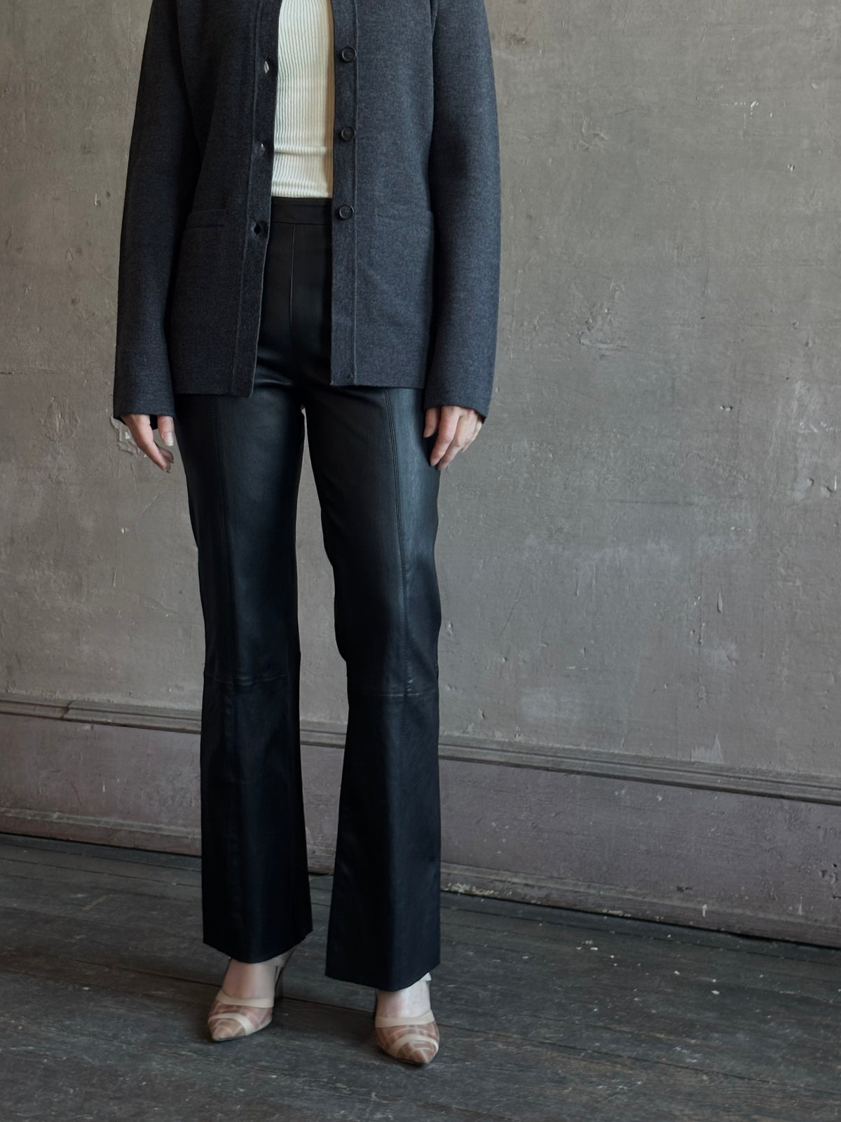 Mature woman wearing SPRWMN Black Ankle Flare Leather Pants Designer Mid-Rise Stretch Leather