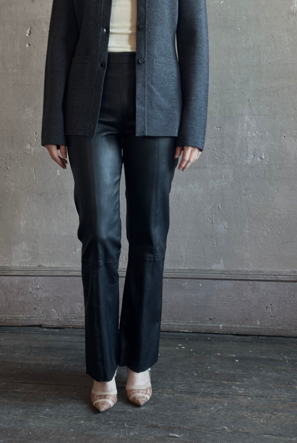 Mature woman wearing SPRWMN Black Ankle Flare Leather Pants Designer Mid-Rise Stretch Leather