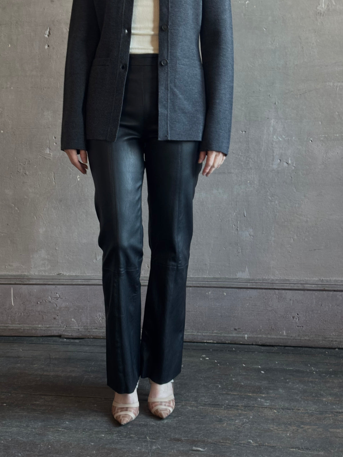 Mature woman wearing SPRWMN Black Ankle Flare Leather Pants Designer Mid-Rise Stretch Leather