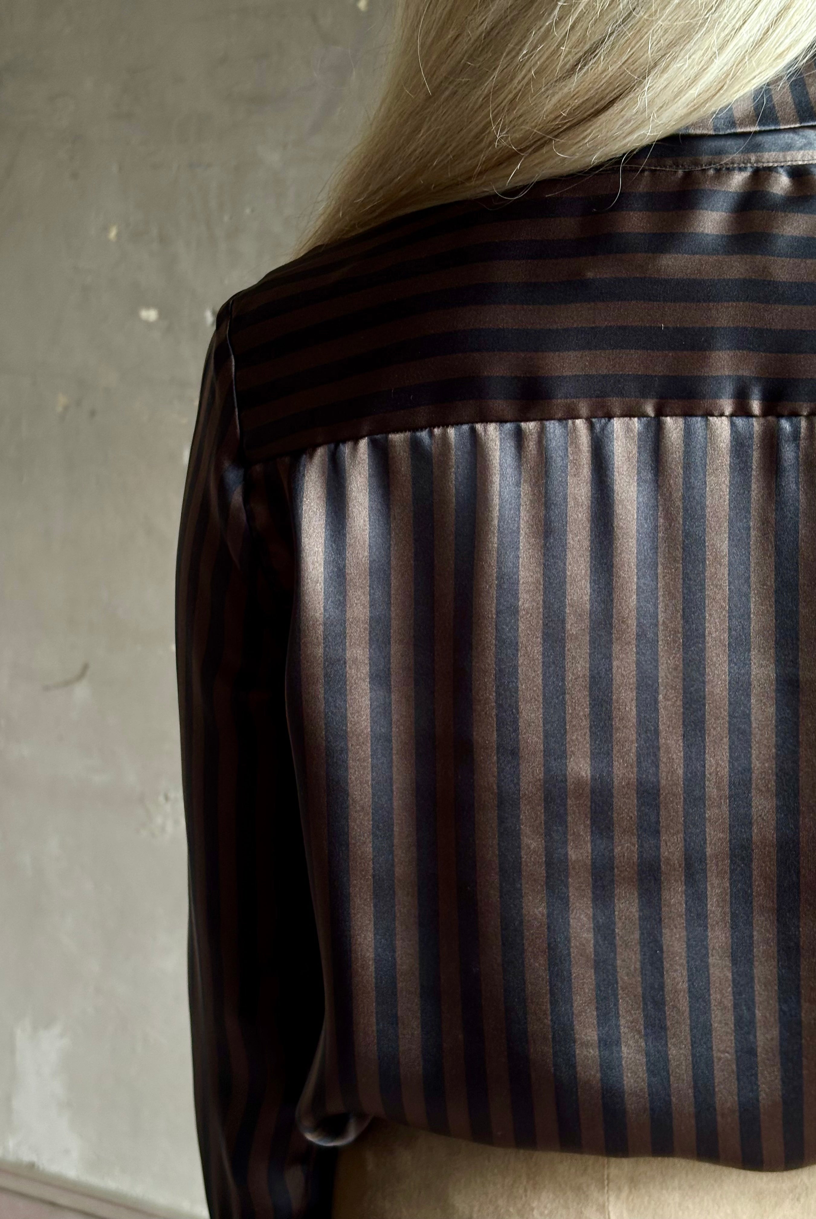 woman wearing luxury brand SPRWMN Fonda silk button up shirt in a black and brown stripe modern classic