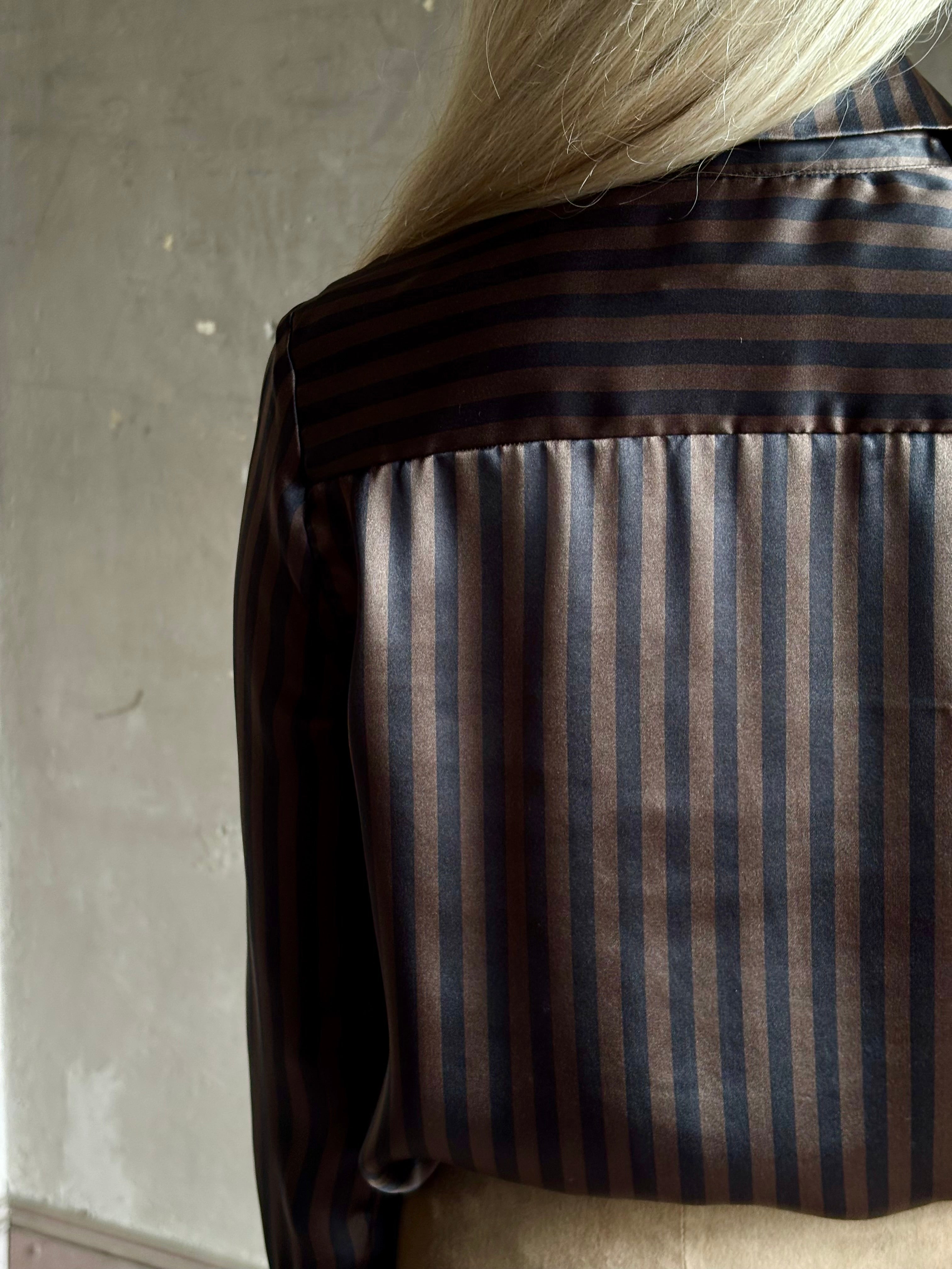 woman wearing luxury brand SPRWMN Fonda silk button up shirt in a black and brown stripe modern classic