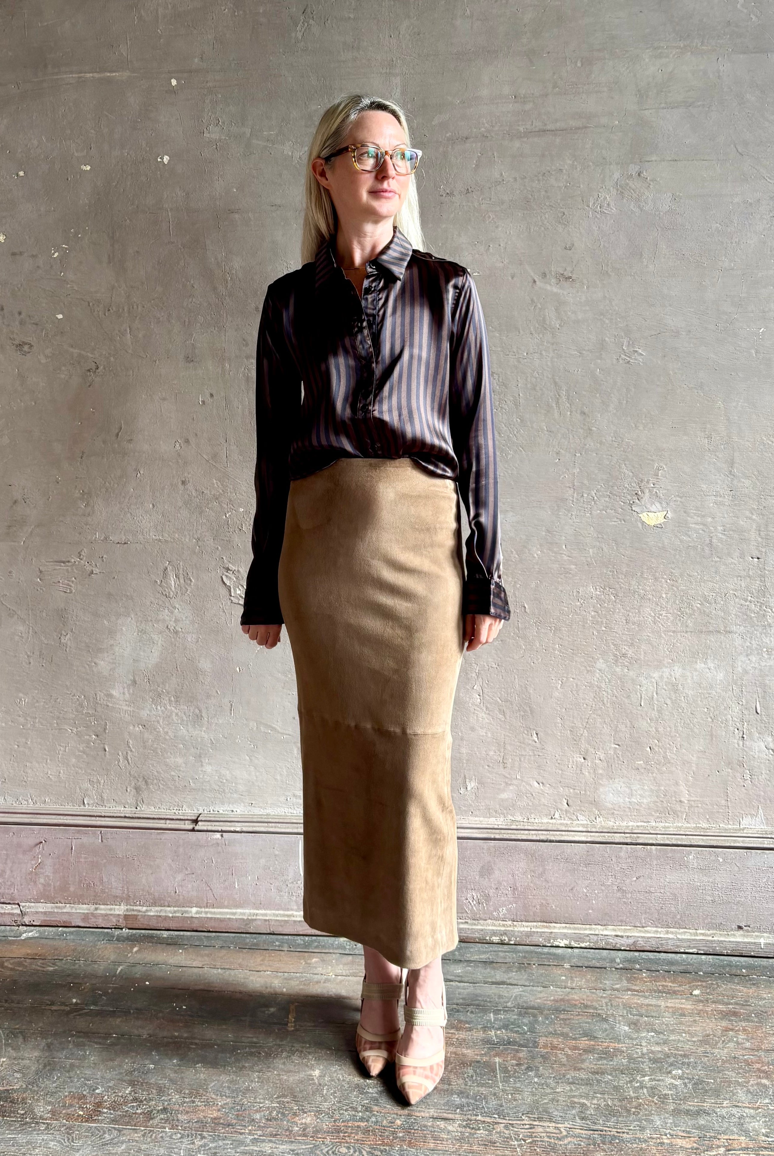 woman wearing luxury brand SPRWMN Fonda silk button up shirt in a black and brown stripe modern classic