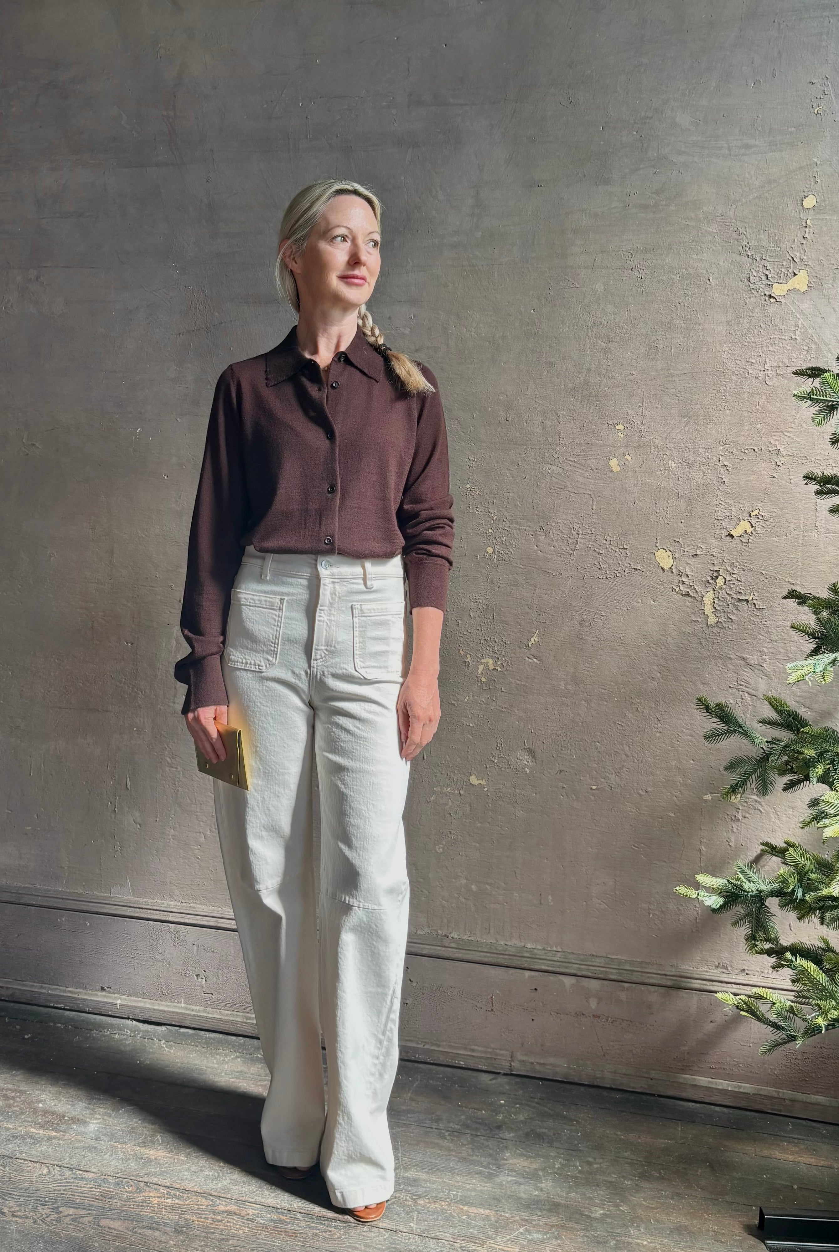 Mature woman wearing elevated casual wear button front Fonda top by SPRWMN in chocolate brown cashmere with long sleeves and a collar