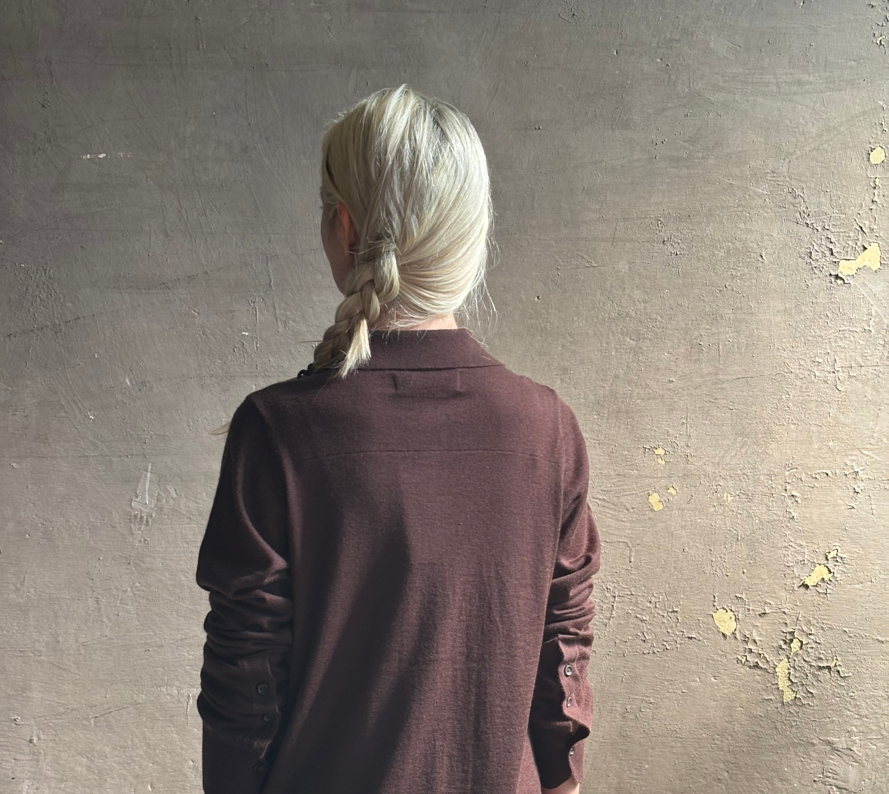 Mature woman wearing elevated casual wear button front Fonda top by SPRWMN in chocolate brown cashmere with long sleeves and a collar