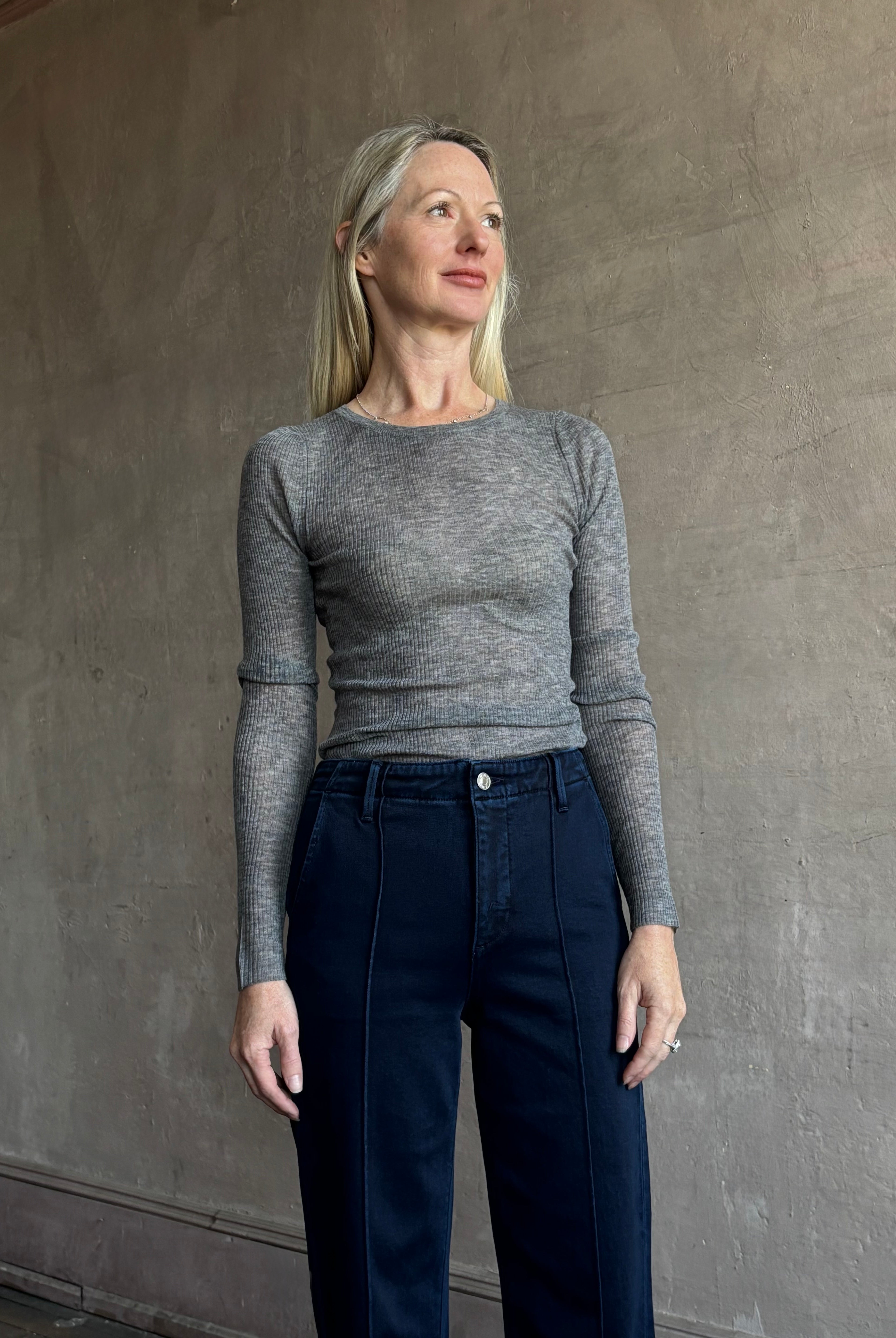 Image of mature woman wearing luxury women's clothing SPRWMN long sleeve baby tee with subtle transparency and lightweight knit