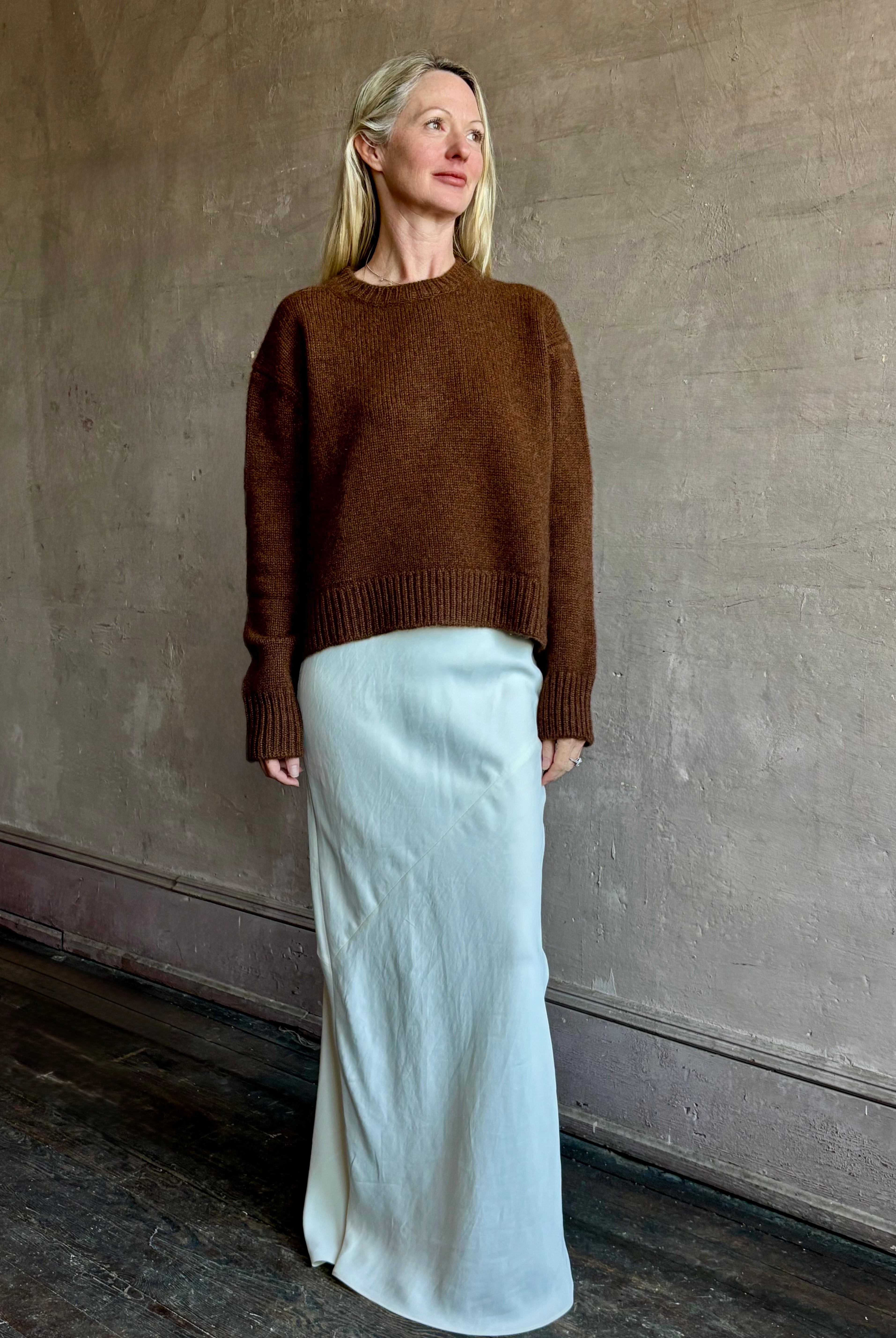 Image of mature woman wearing women's luxury brand SPRWNM oversized long sleeve brown sweater with crewneck