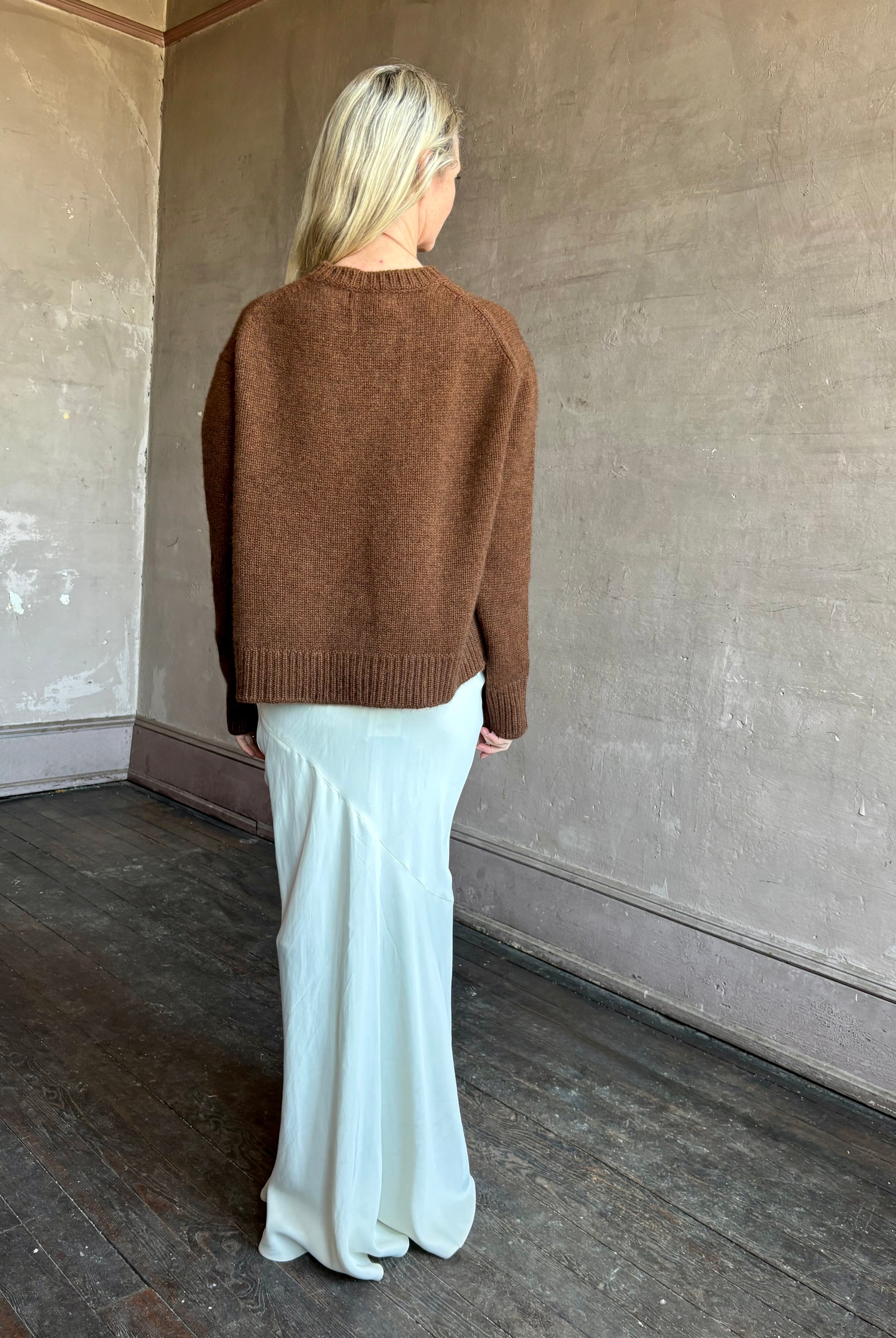 Image of mature woman wearing women's luxury brand SPRWNM oversized long sleeve brown sweater with crewneck