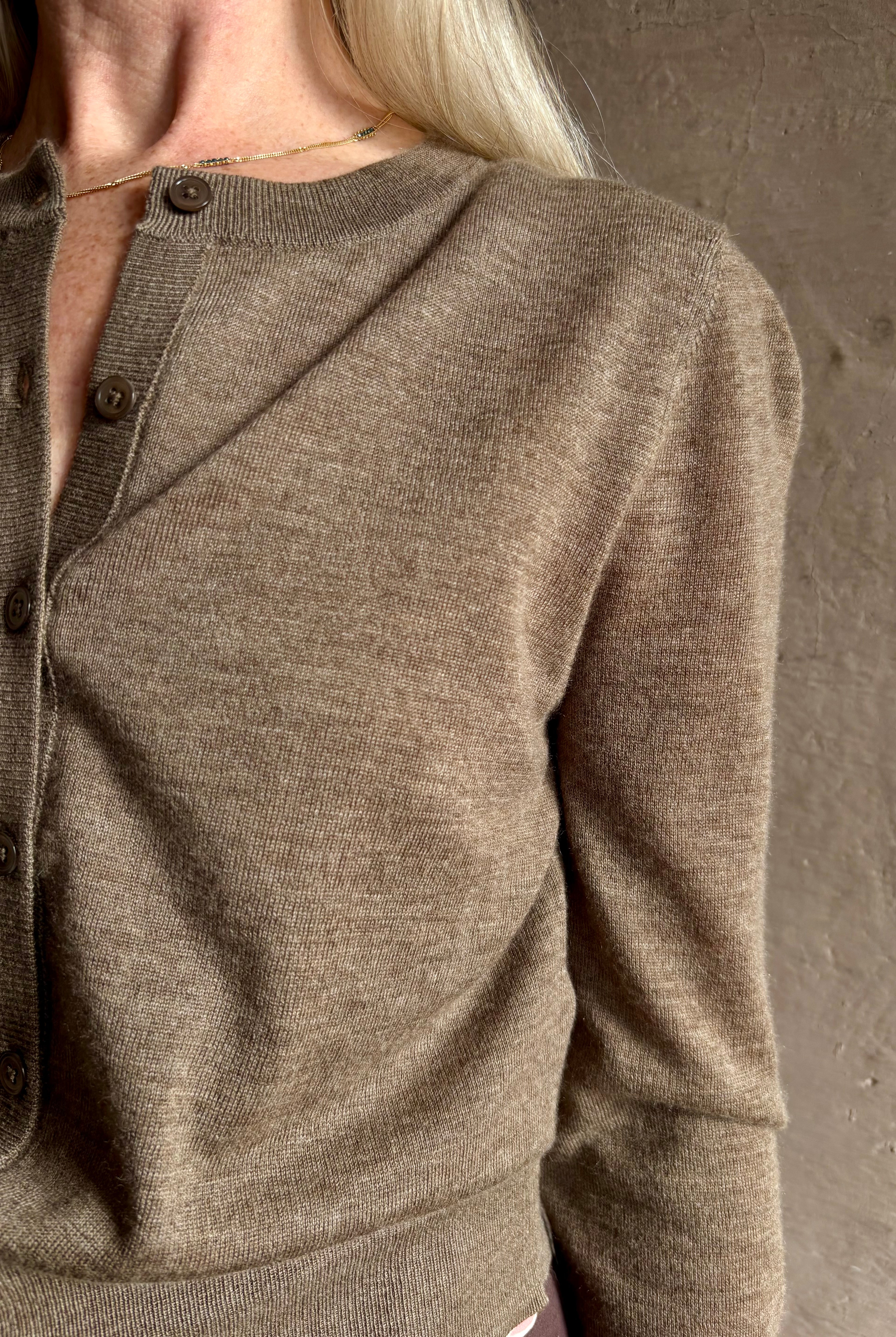 Mature woman wearing designer SPRWMN brown knit cashmere button front layering or stand alone baby cardigan