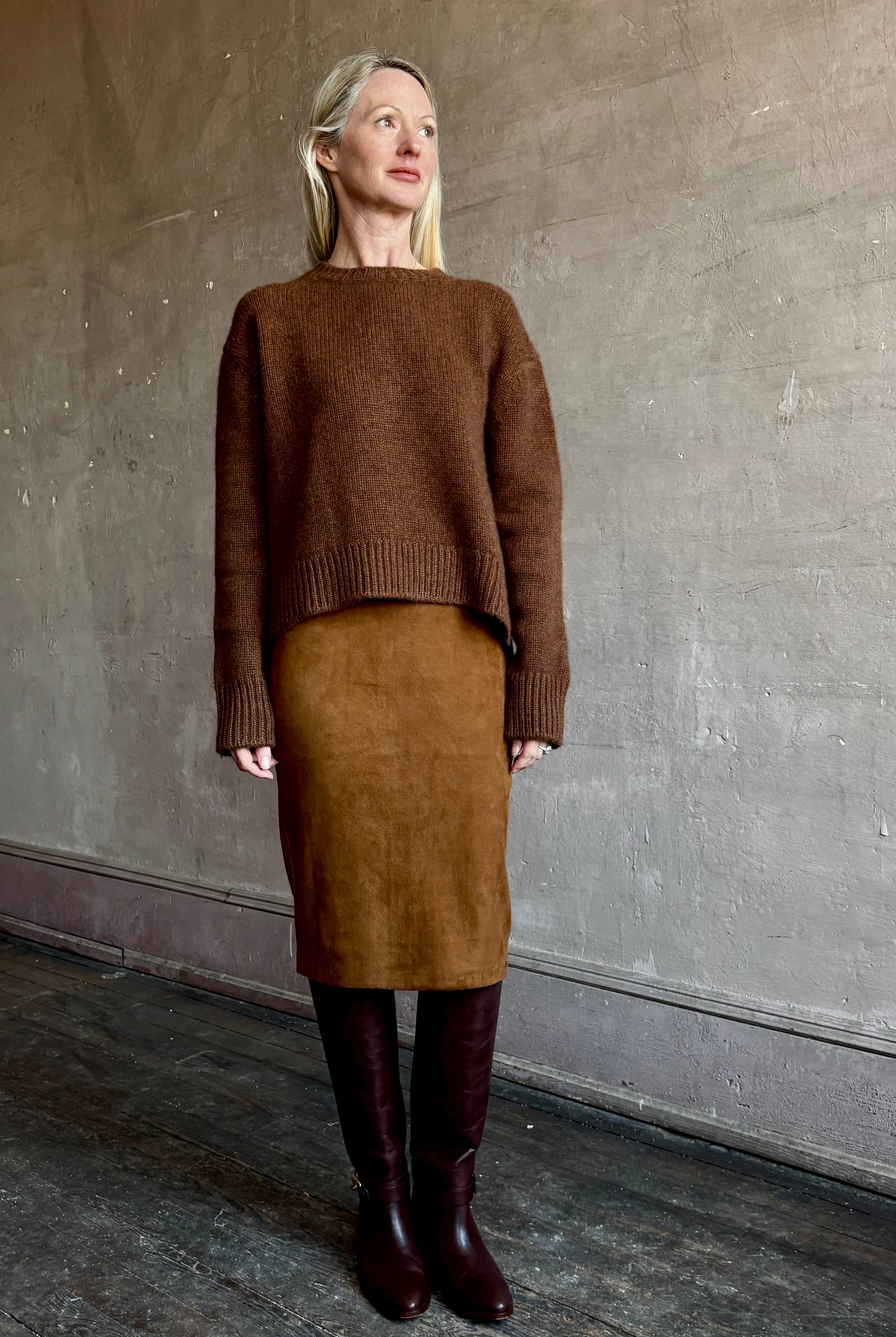Image of mature woman wearing contemporary designer SPRWMN brown suede leather pencil skirt and cashmere sweater
