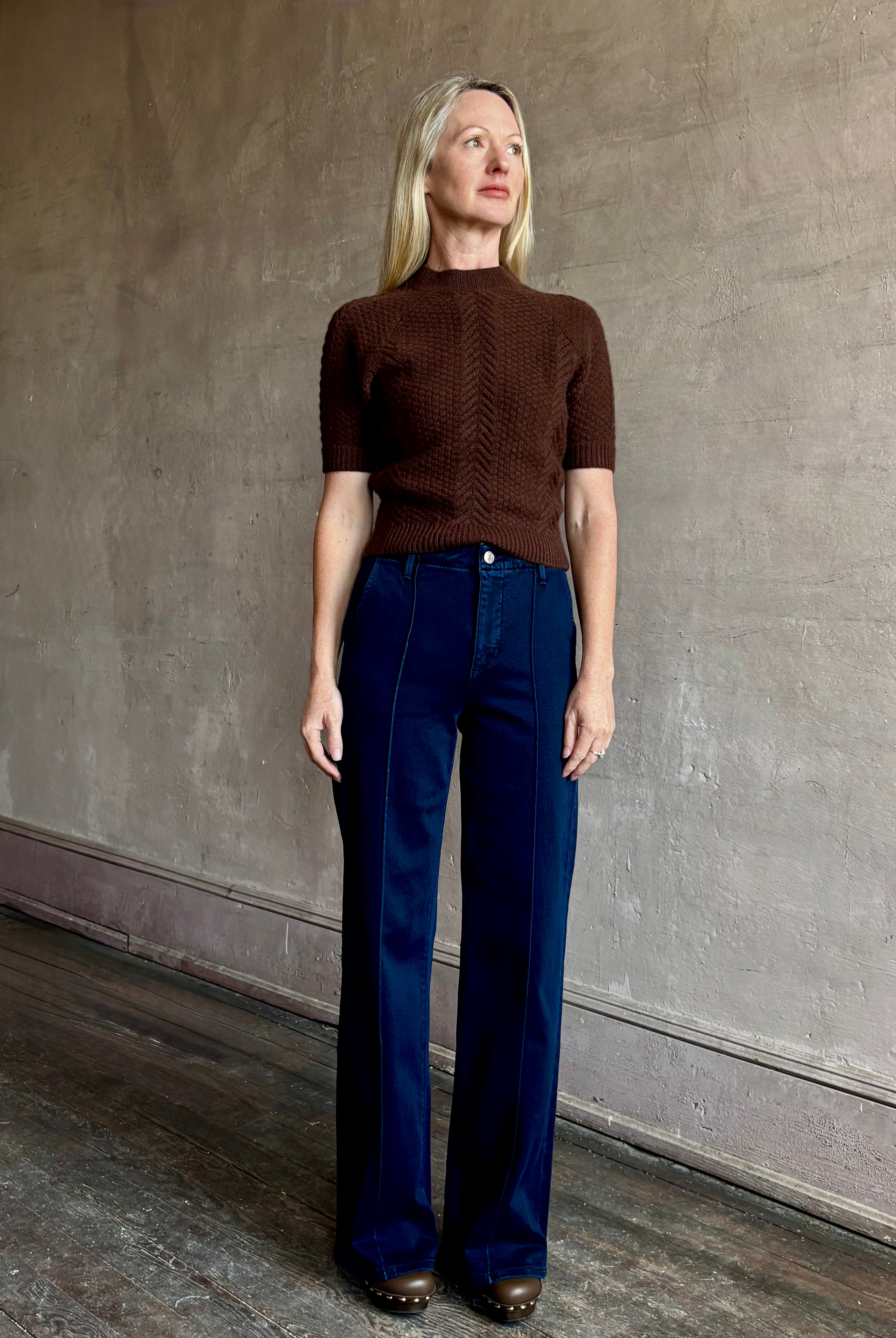 Image of mature woman wearing high end luxury designer SPRWMN short sleeve brown cashmere sweater with beautiful cable texture pattern
