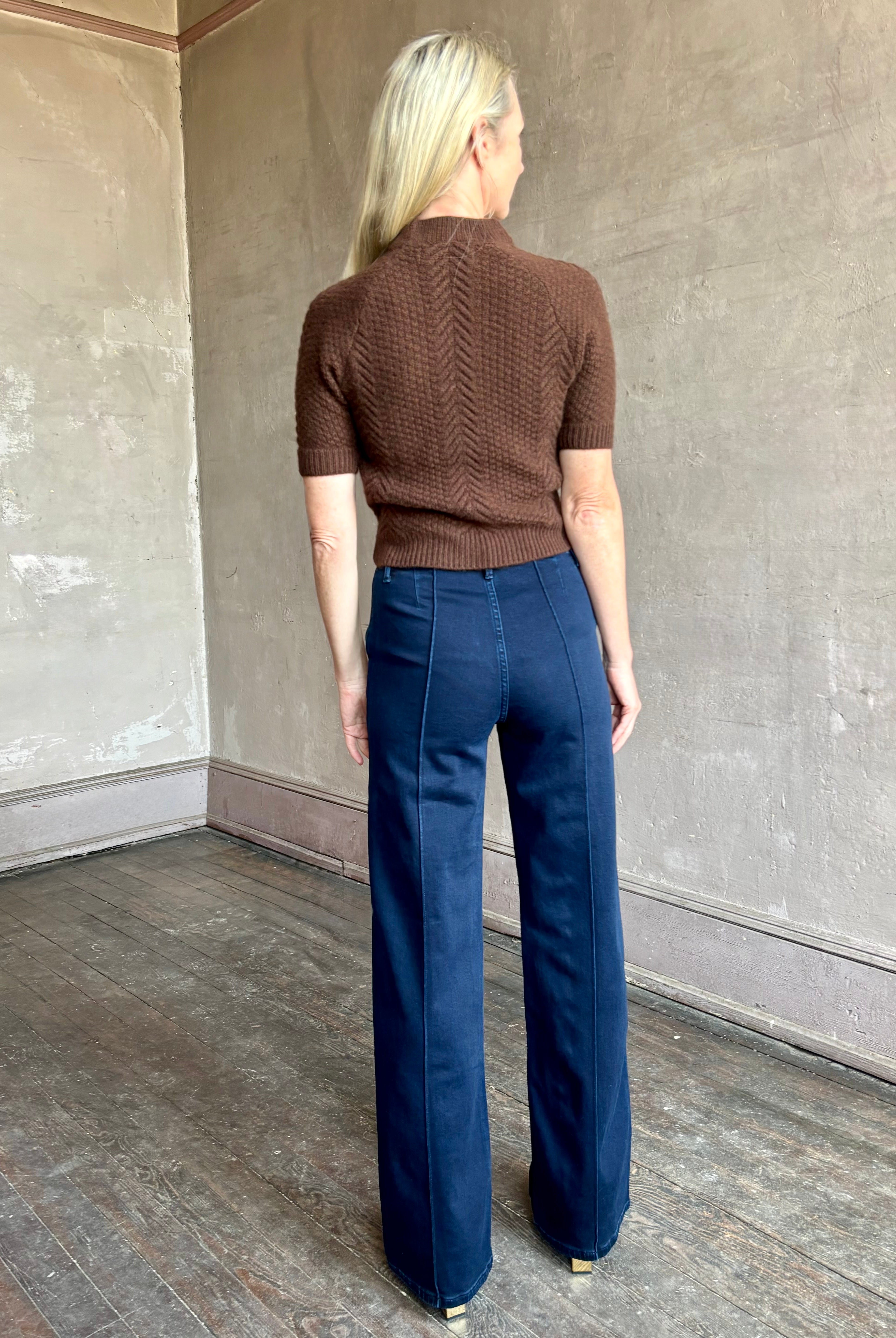 Image of mature woman wearing high end luxury designer SPRWMN short sleeve brown cashmere sweater with beautiful cable texture pattern