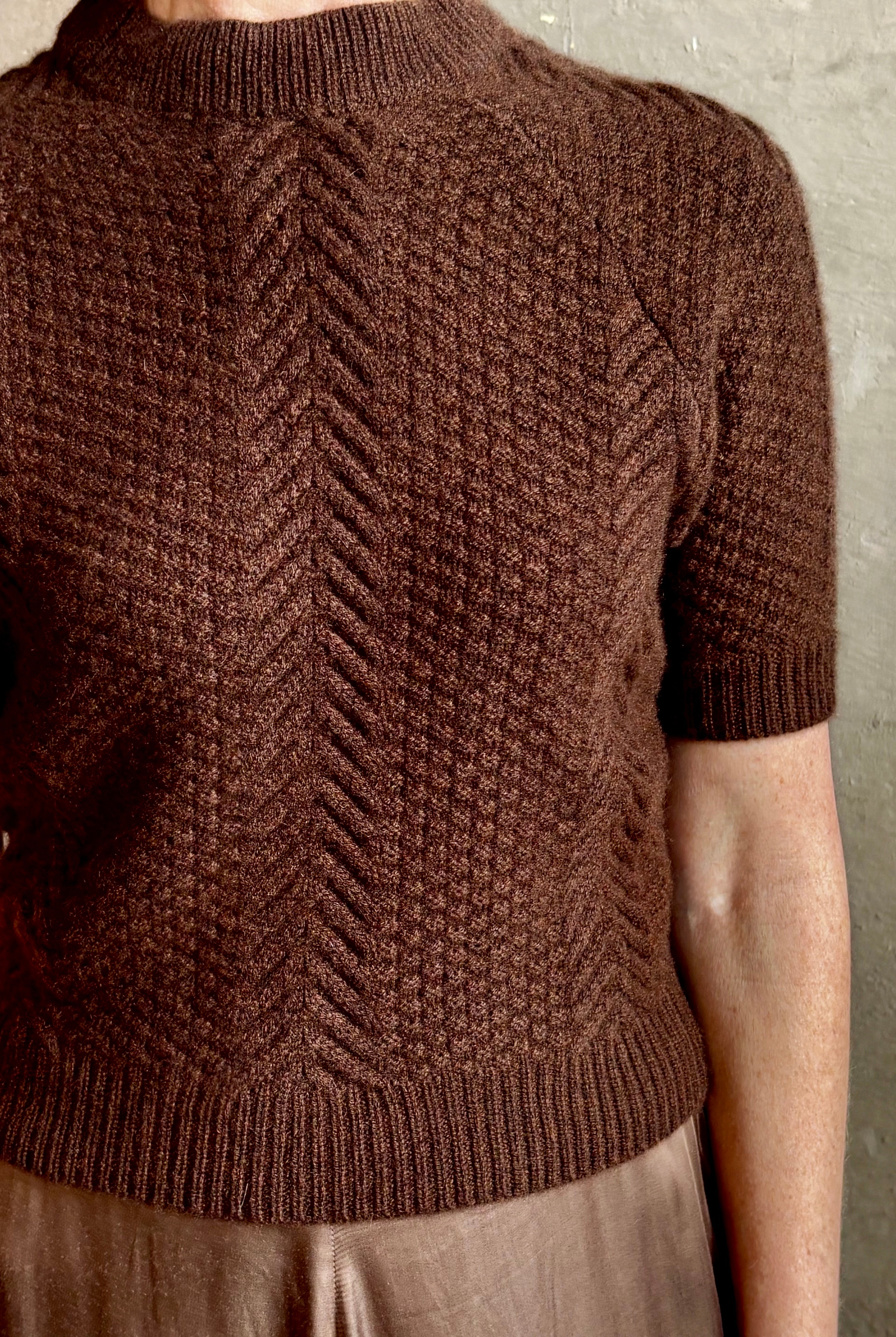 mature woman wearing luxury designer SPRWMN short sleeve brown cashmere sweater with cable texture crew neck