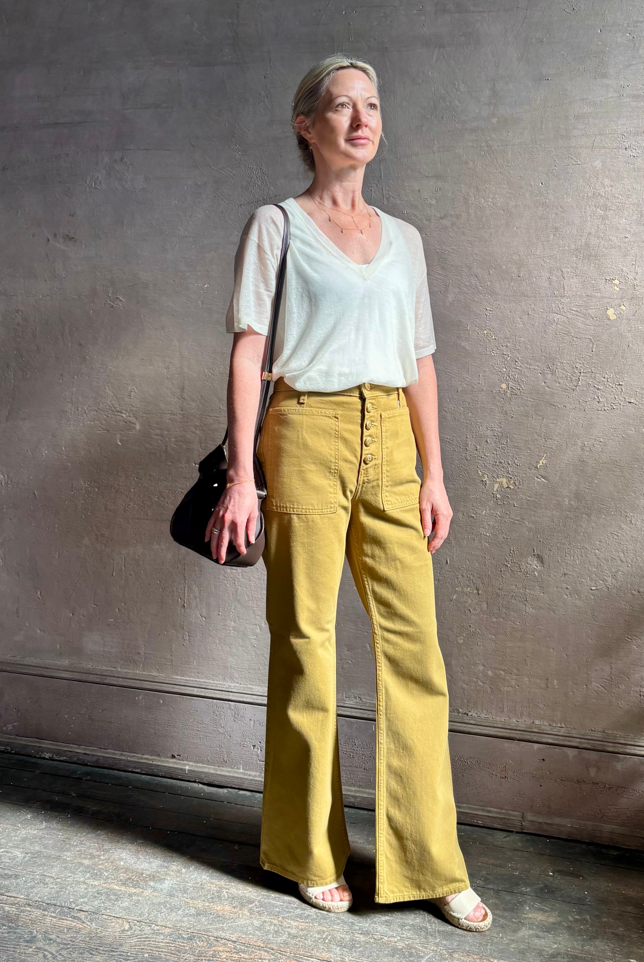 Mature woman wearing SPRWMN lightweight ivory wool sweater short sleeve v-neck in relaxed fit t-shirt