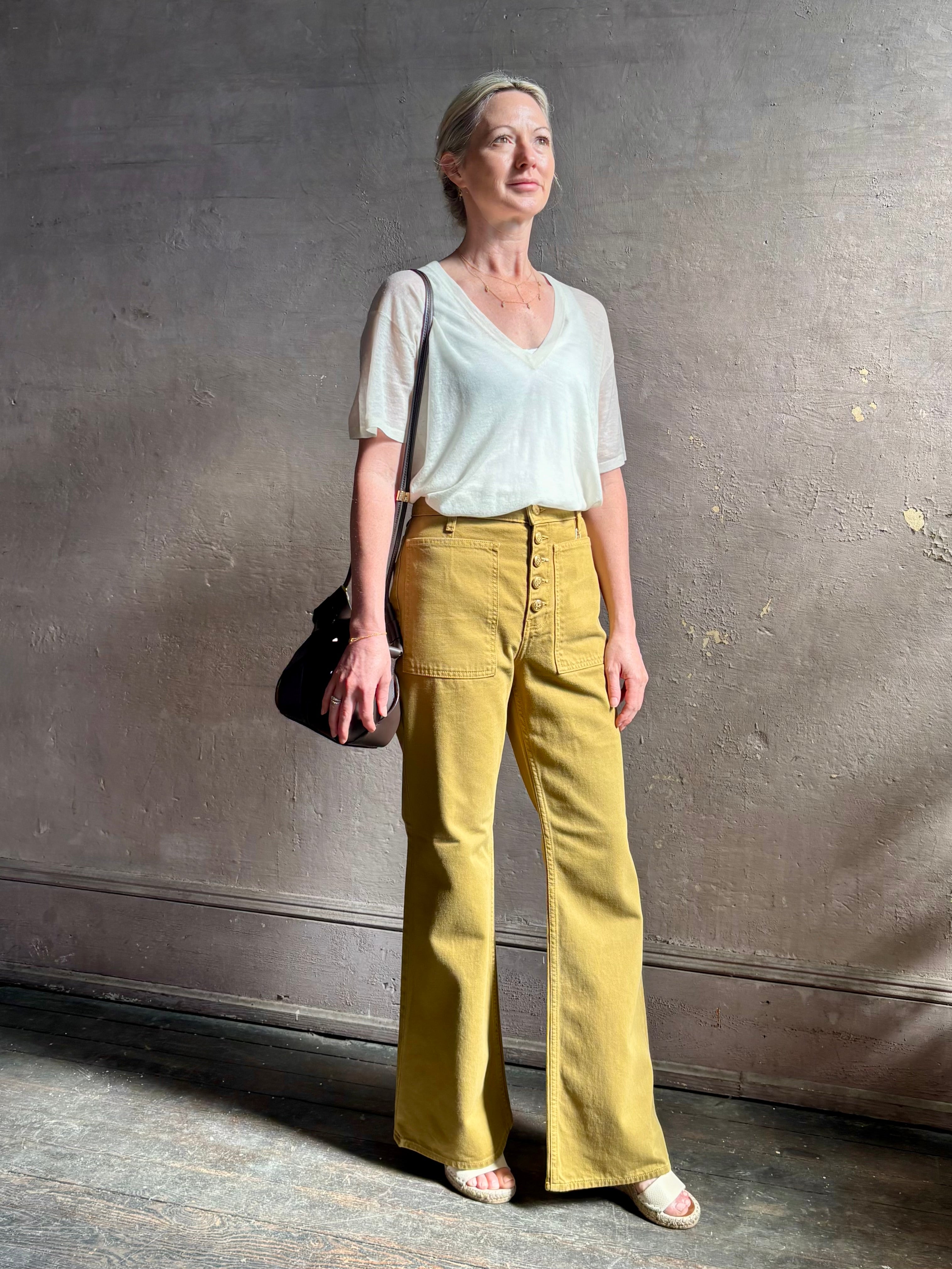 Mature woman wearing SPRWMN lightweight ivory wool sweater short sleeve v-neck in relaxed fit t-shirt