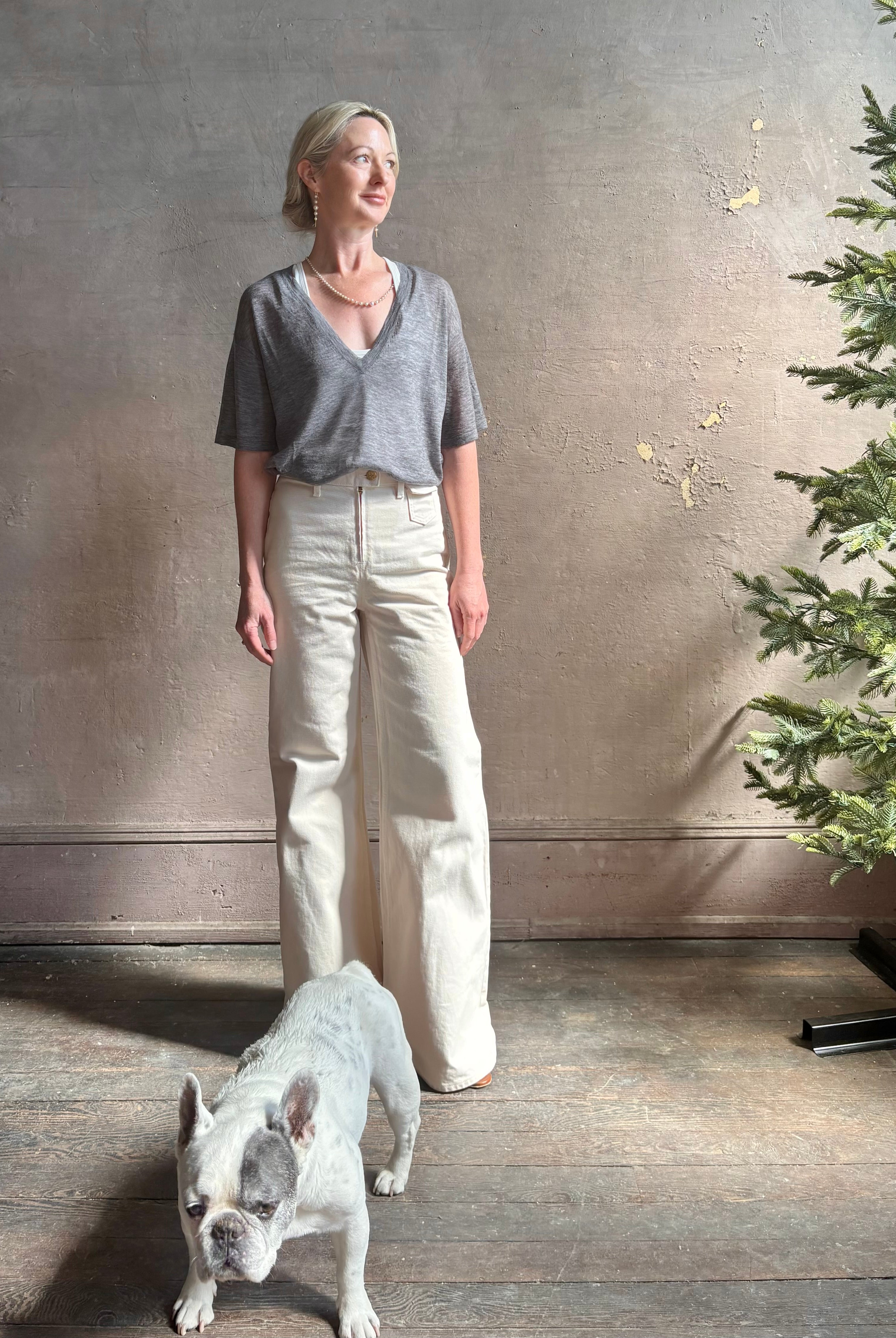Mature woman wearing premium polished layer SPRWMN grey wool tee shirt with a v-neck and short sleeves